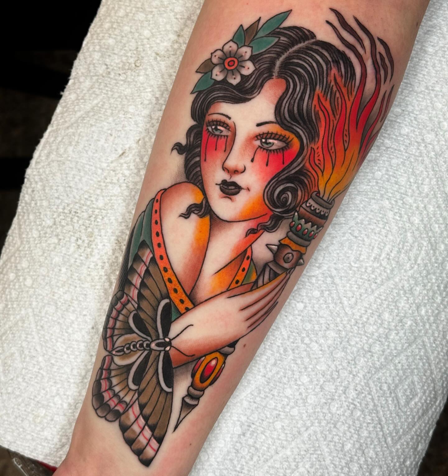 Woman with butterfly American traditional tattoo on the forearm by Graham Edward Vogel