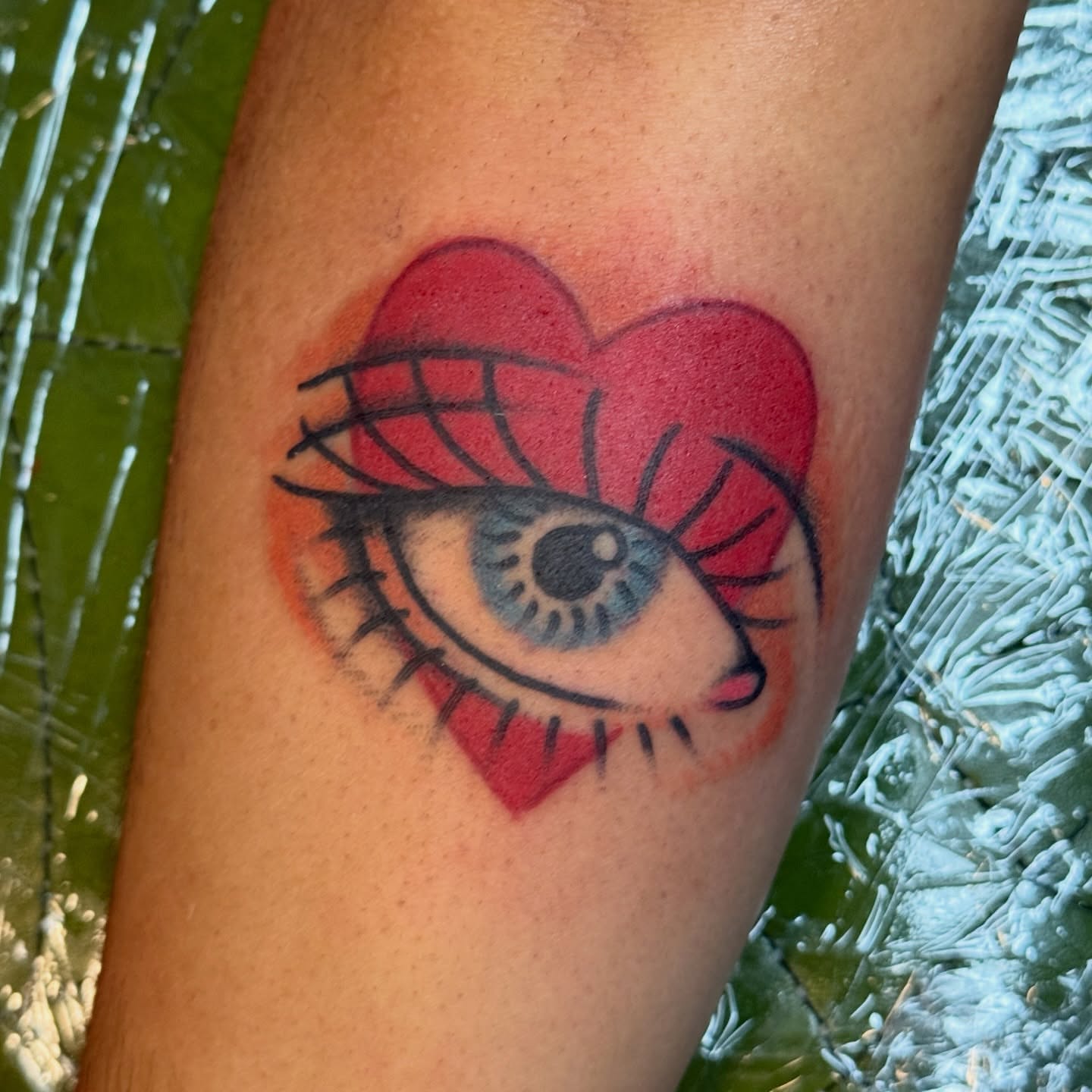 Eye within heart realism tattoo on the forearm by Traddy Maddie ๐