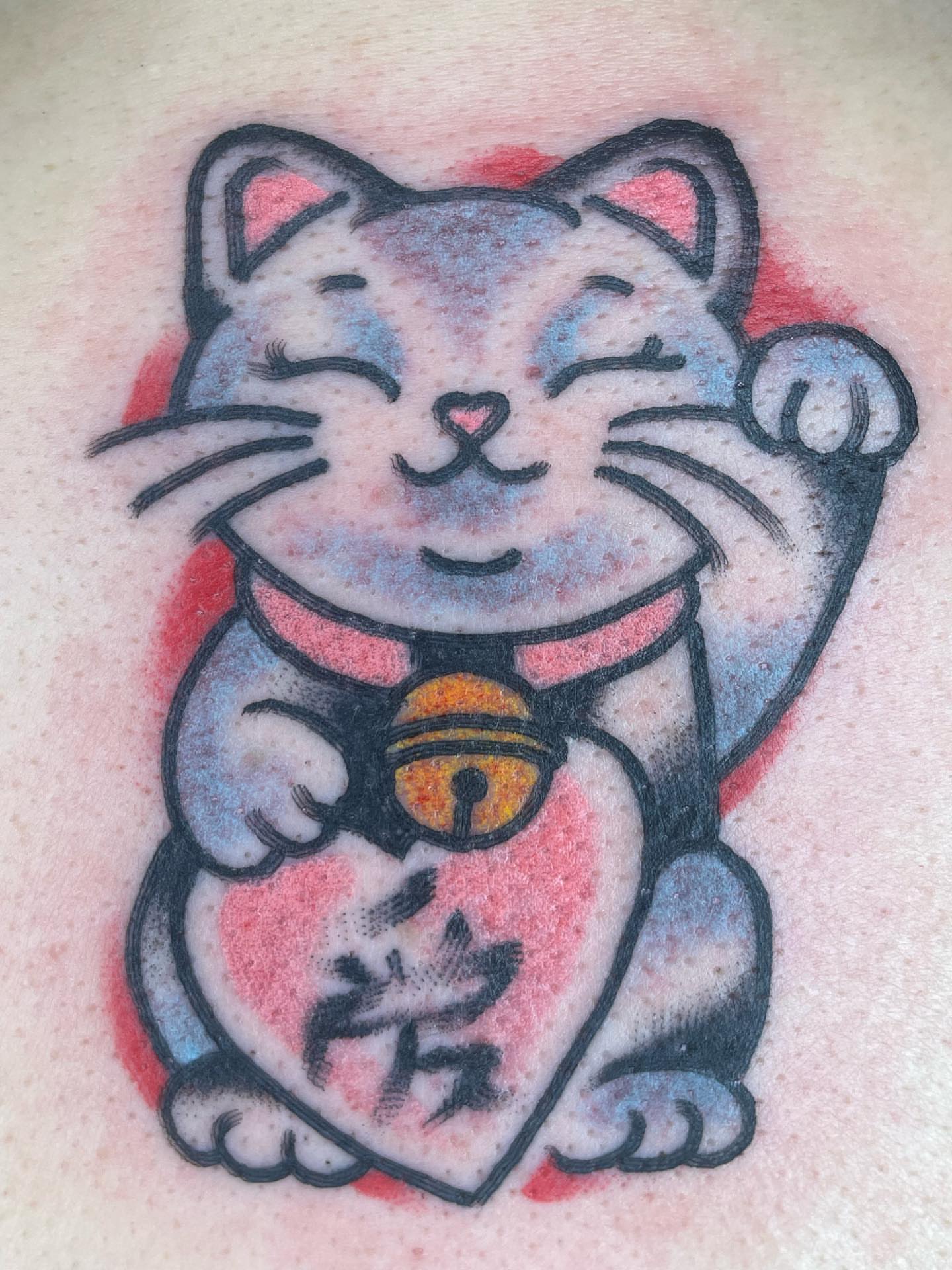 Lucky cat American traditional tattoo on the upper arm by Nicholas M. Passeri