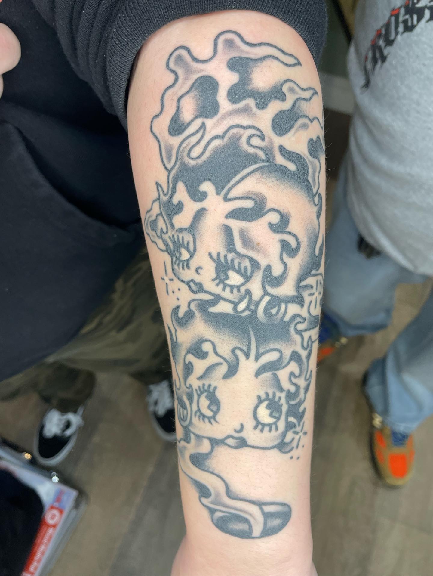 Abstract creature black and grey tattoo on the forearm by Nicholas M. Passeri