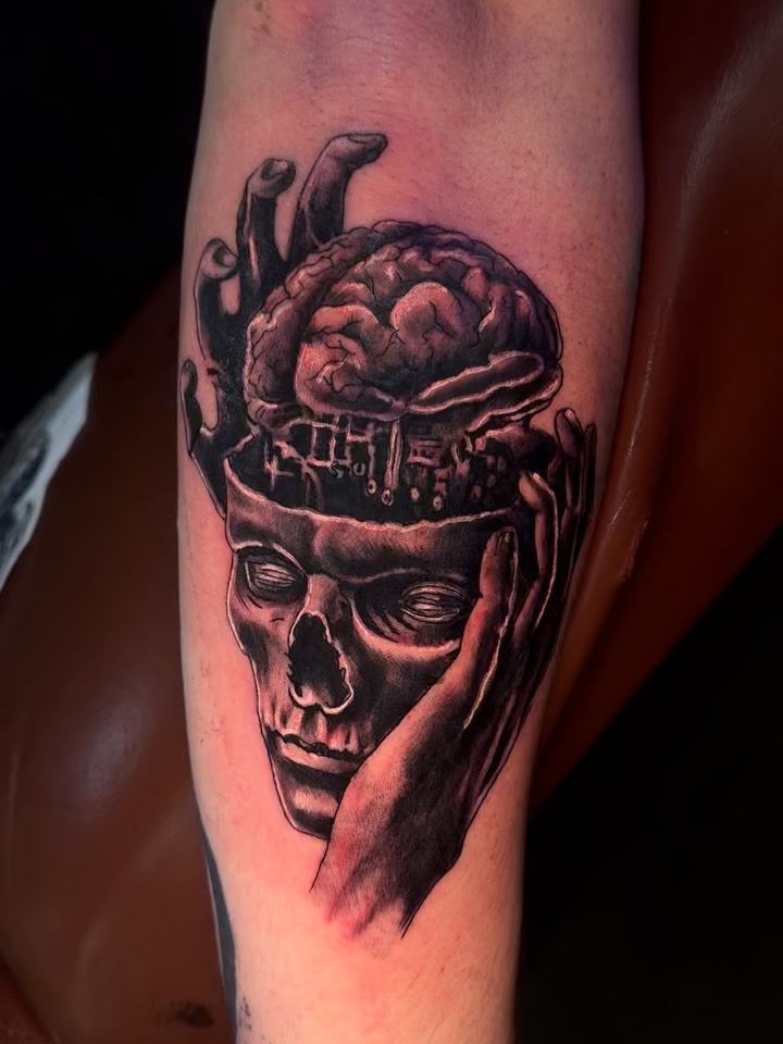 Skull with brain realism tattoo on the forearm by Therapy ink