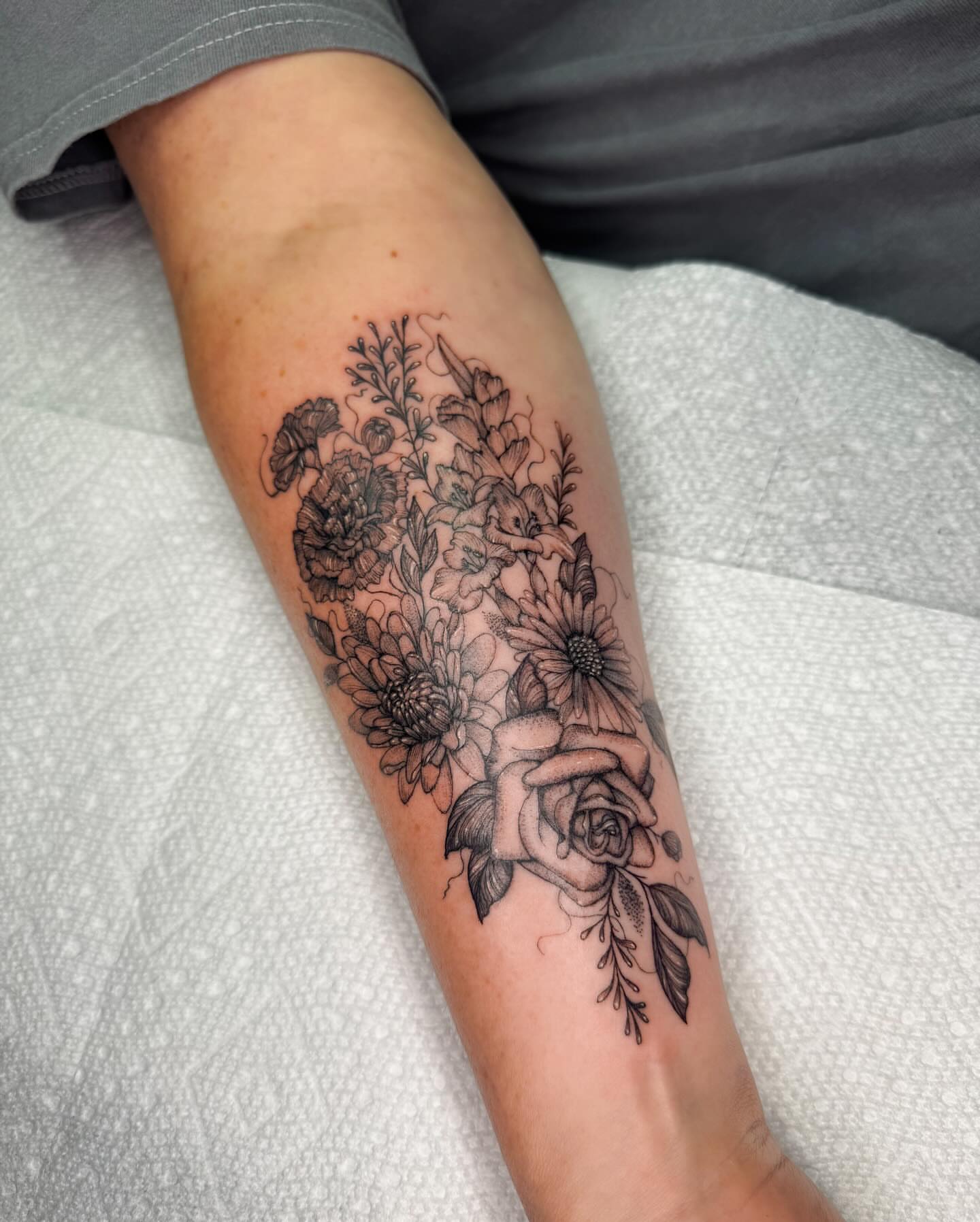 Floral bouquet realism tattoo on the forearm by Natasha Rachel Fineline Tattoos Nashville