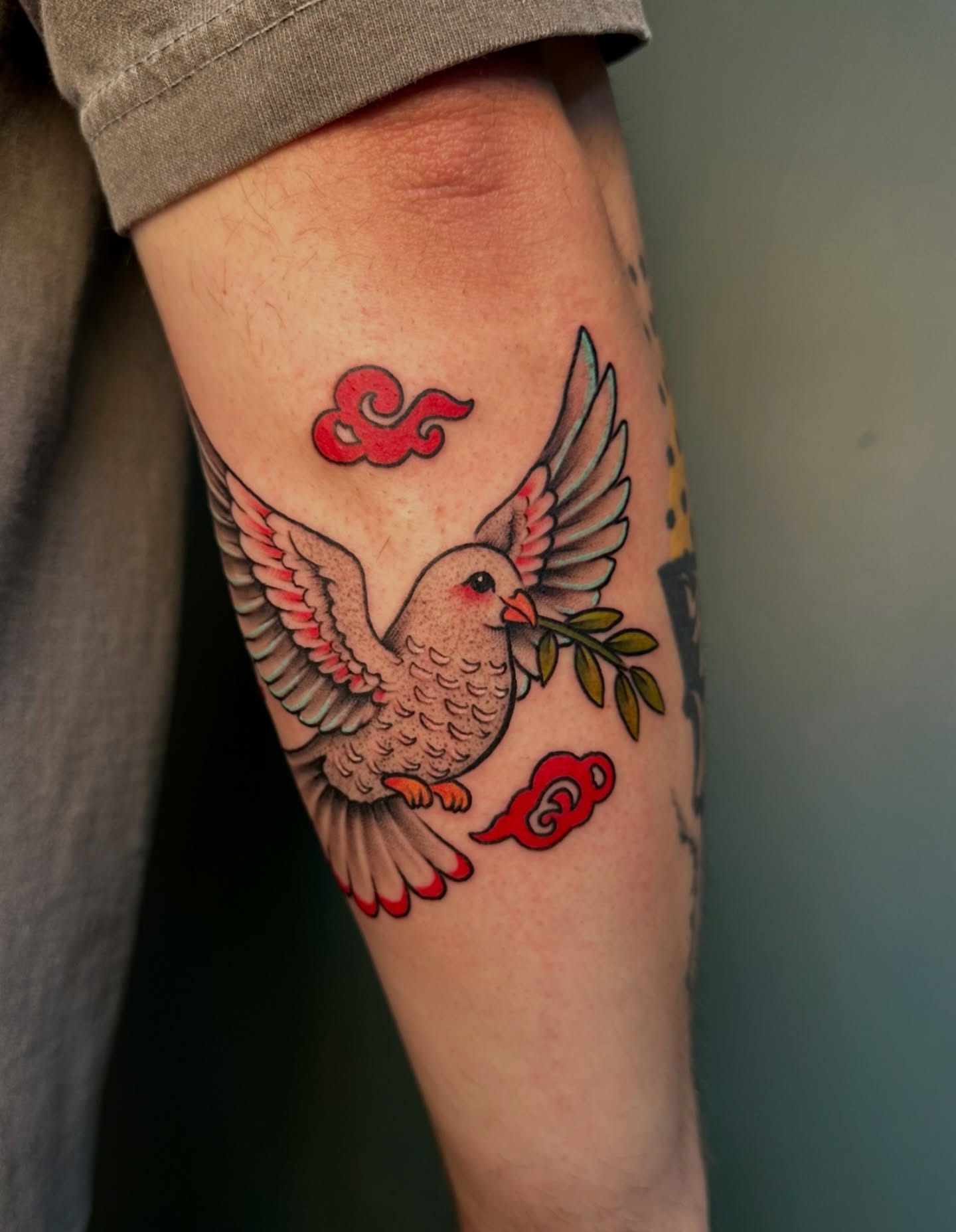 Bird with branch American traditional tattoo on the forearm by Sarah Margaret