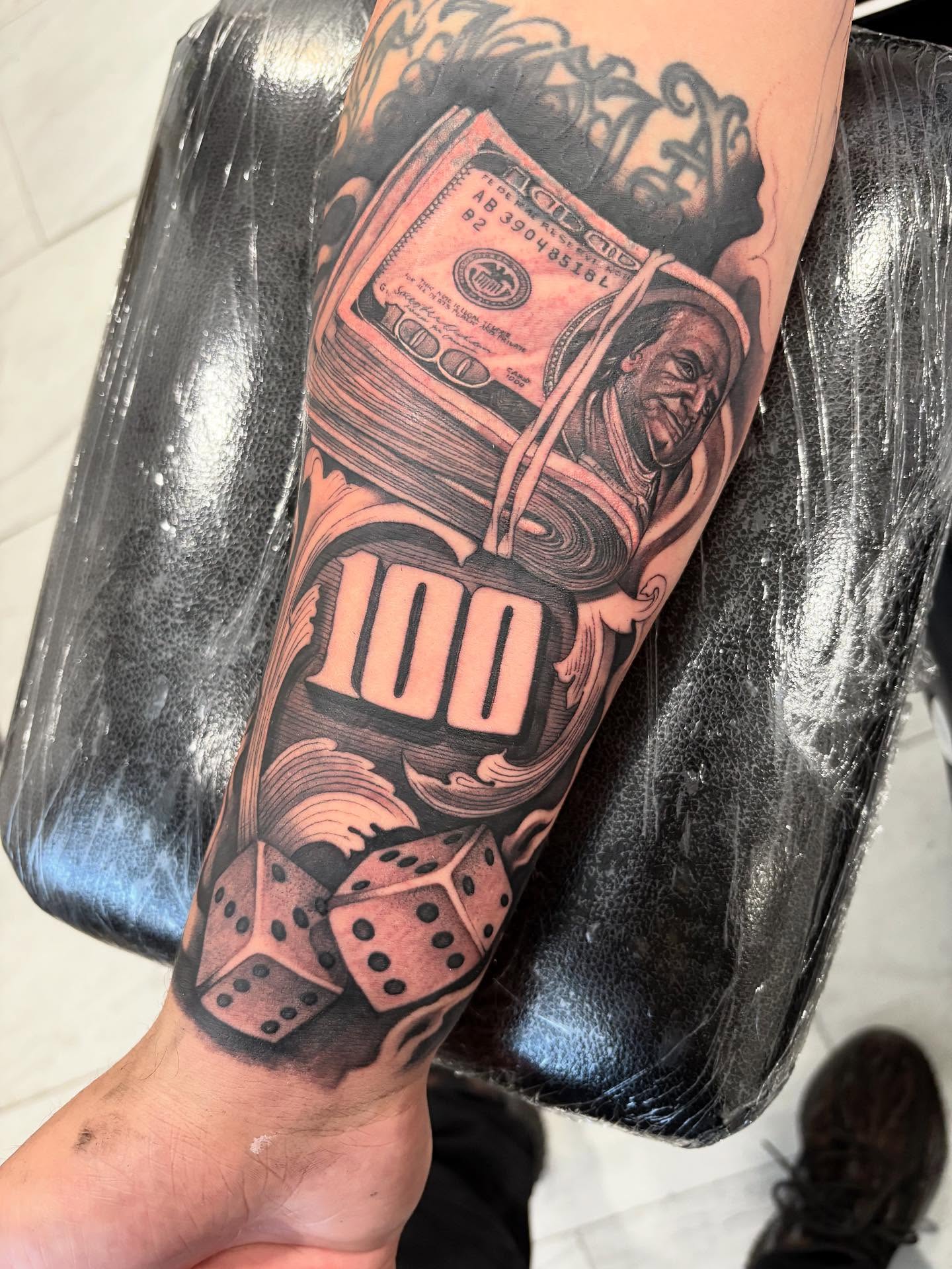 Money and dice American traditional tattoo on the forearm by Juan Lira