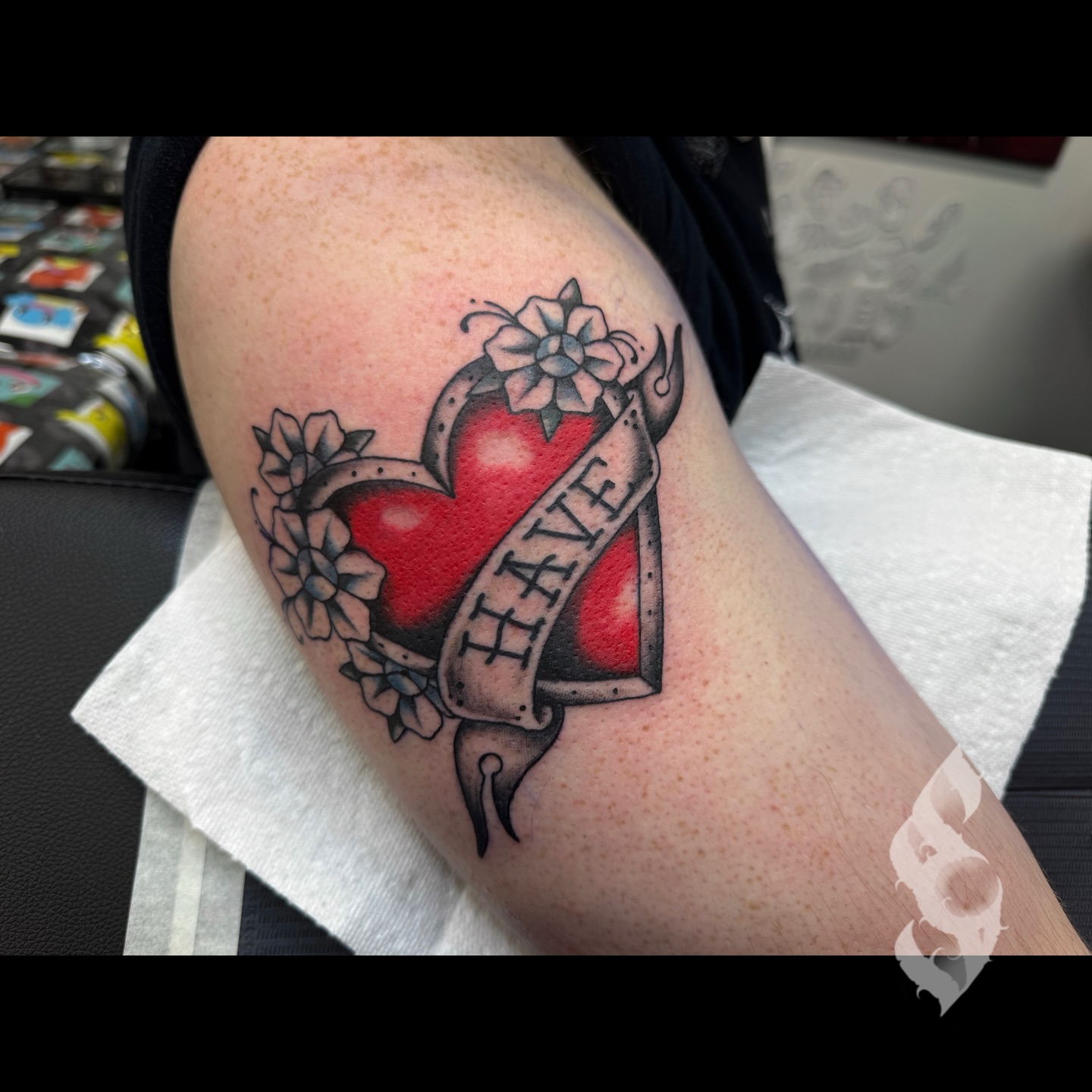 Heart with ribbon American traditional tattoo on the forearm by Amanda Stampfly