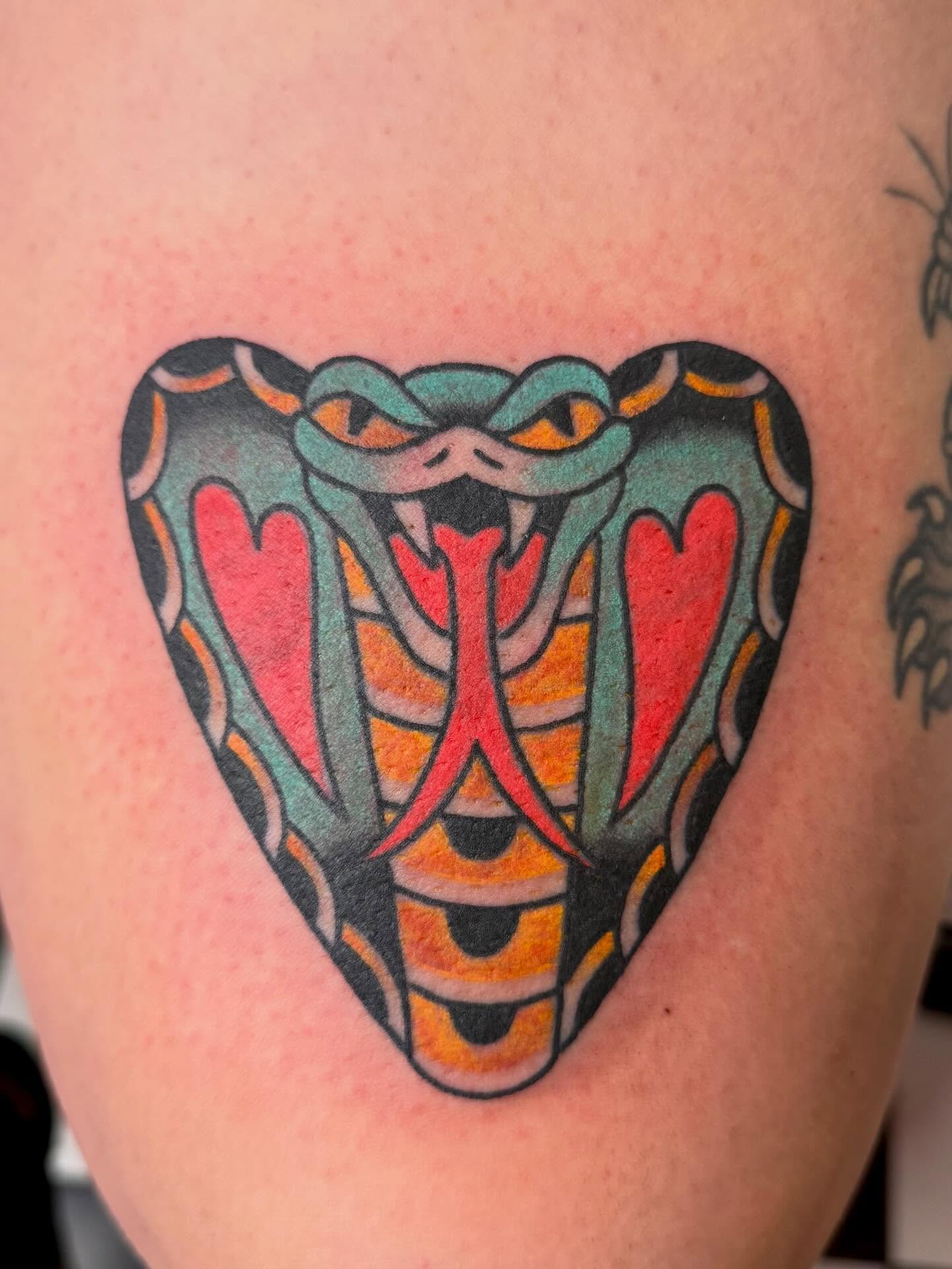 Snake American traditional tattoo on the thigh by Emma Eaton