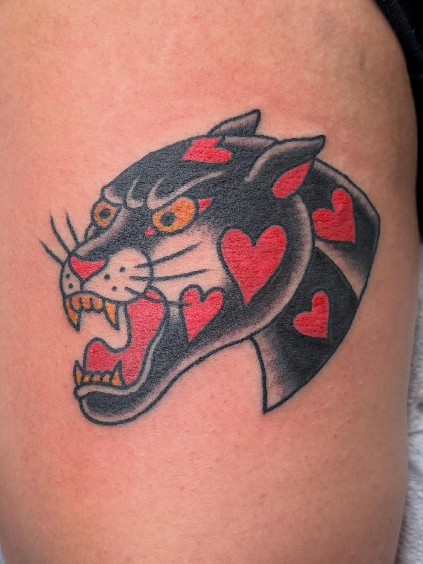 Panther with hearts American traditional tattoo on the shoulder by Emma Eaton