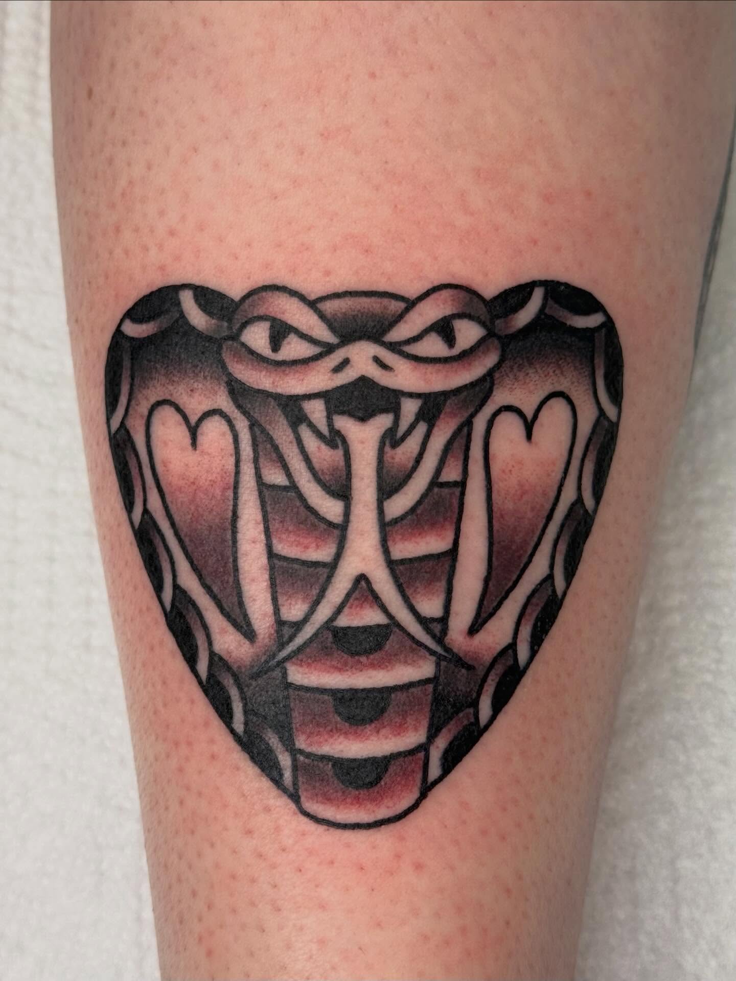 Snake American traditional tattoo on the forearm by Emma Eaton