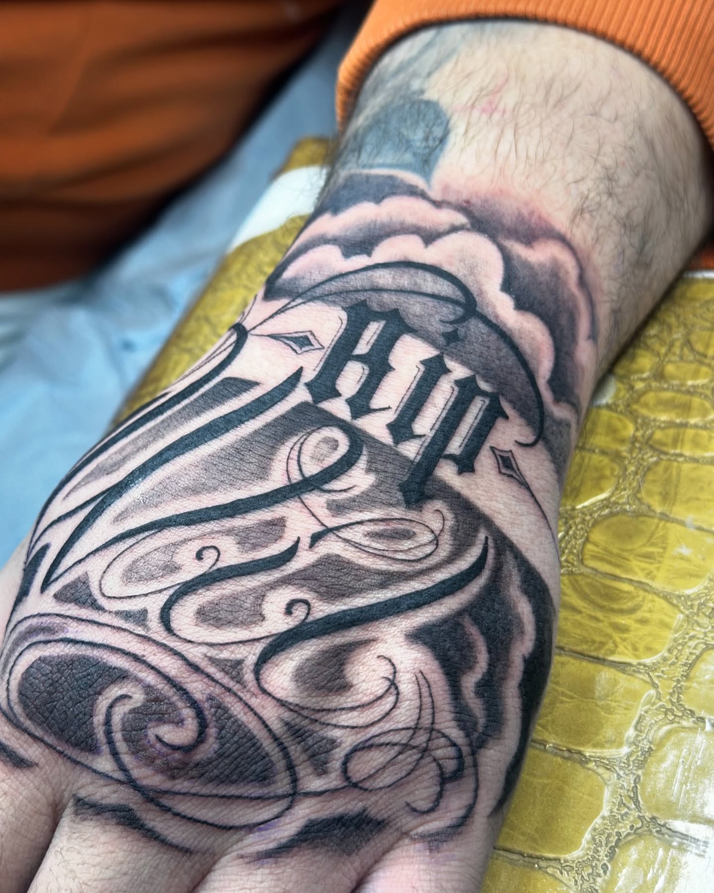 Swirls and lettering black and grey tattoo on the forearm by Tattoo Artist Bay Area - Lorenzo, Berkeley, California