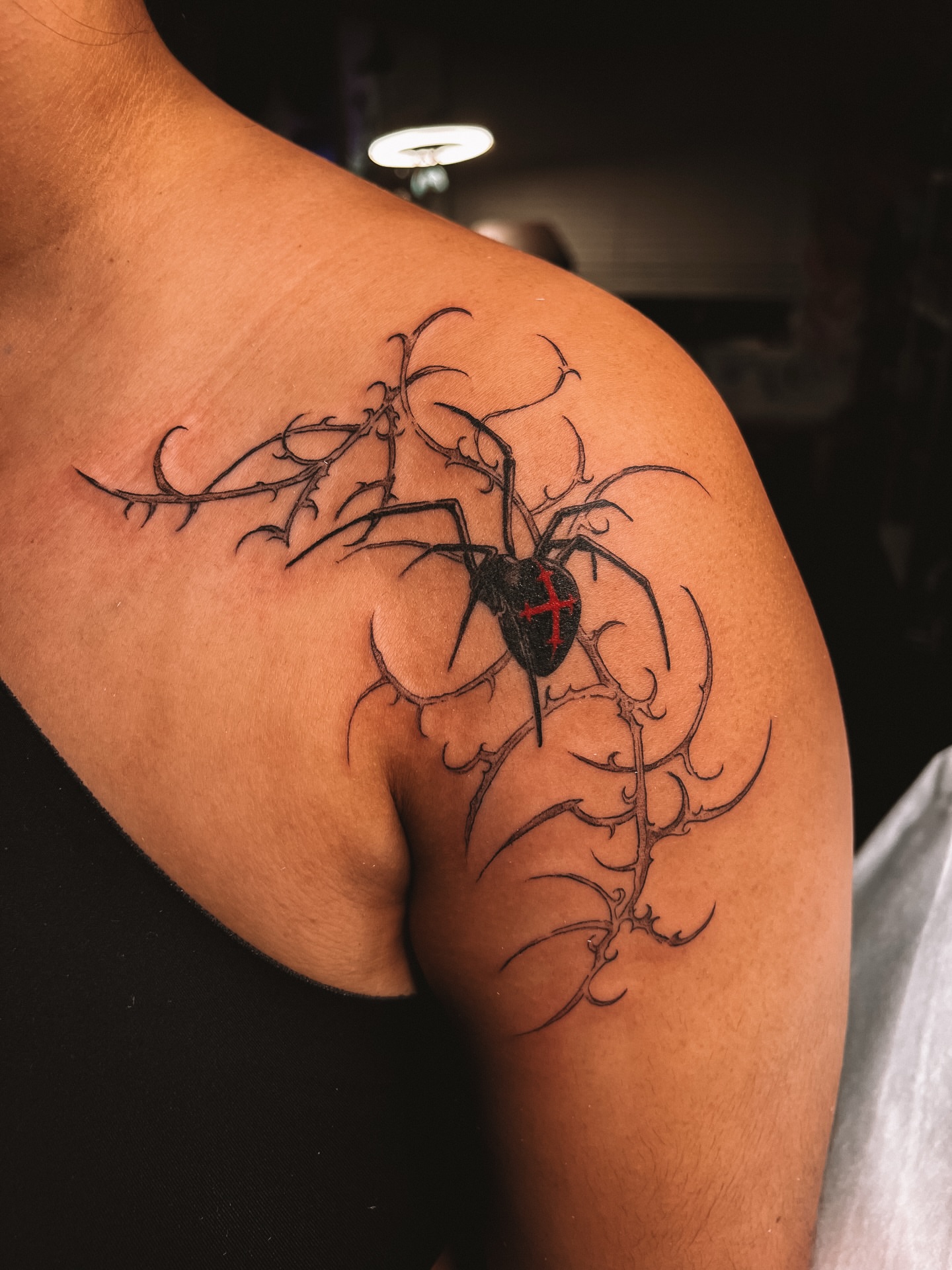 Spider blackwork tattoo on the shoulder by sebs phạm, Los Angeles, California
