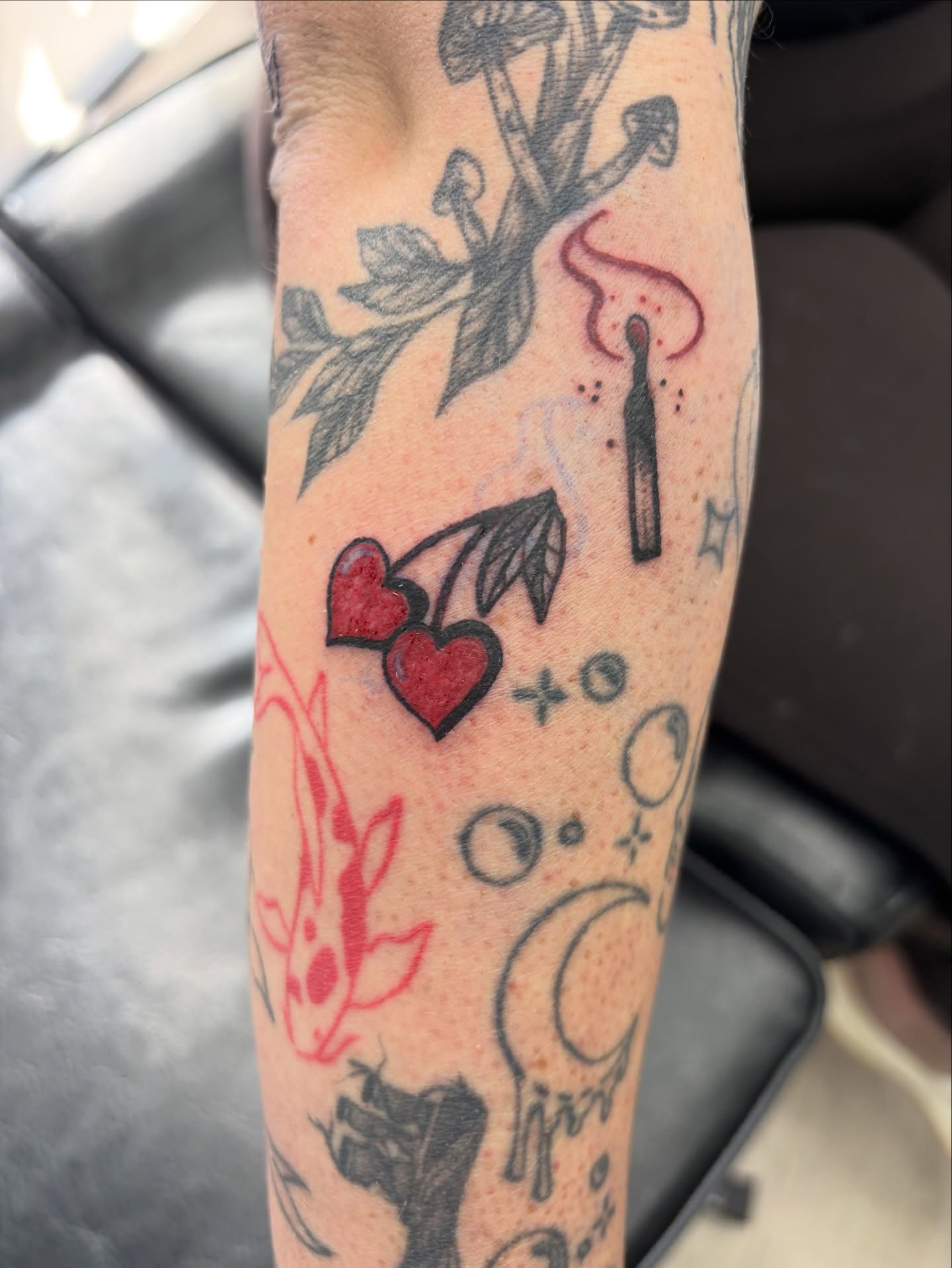 Cherry hearts and candle American traditional tattoo on the forearm by Calen Copeland