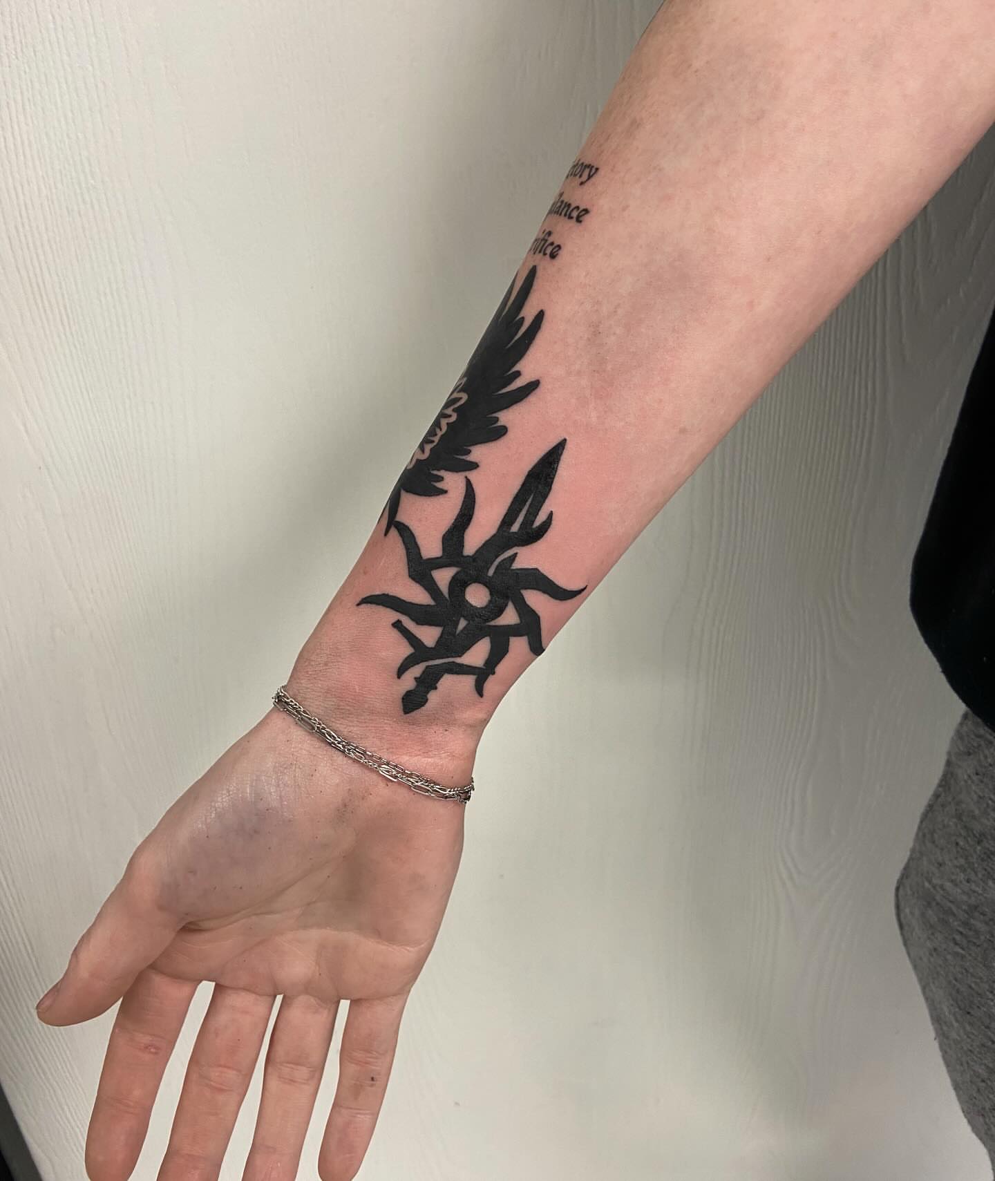 Sun and wings black and grey tattoo on the forearm by Sophia