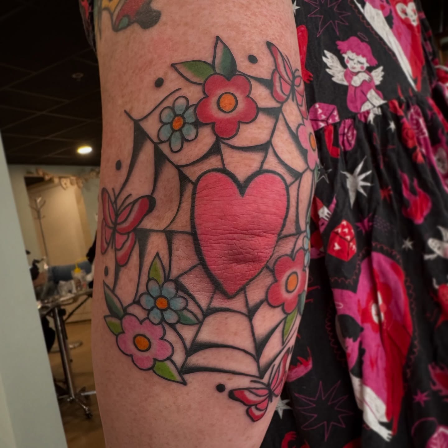 Heart and flowers American traditional tattoo on the forearm by Kaley, Des Moines, Iowa