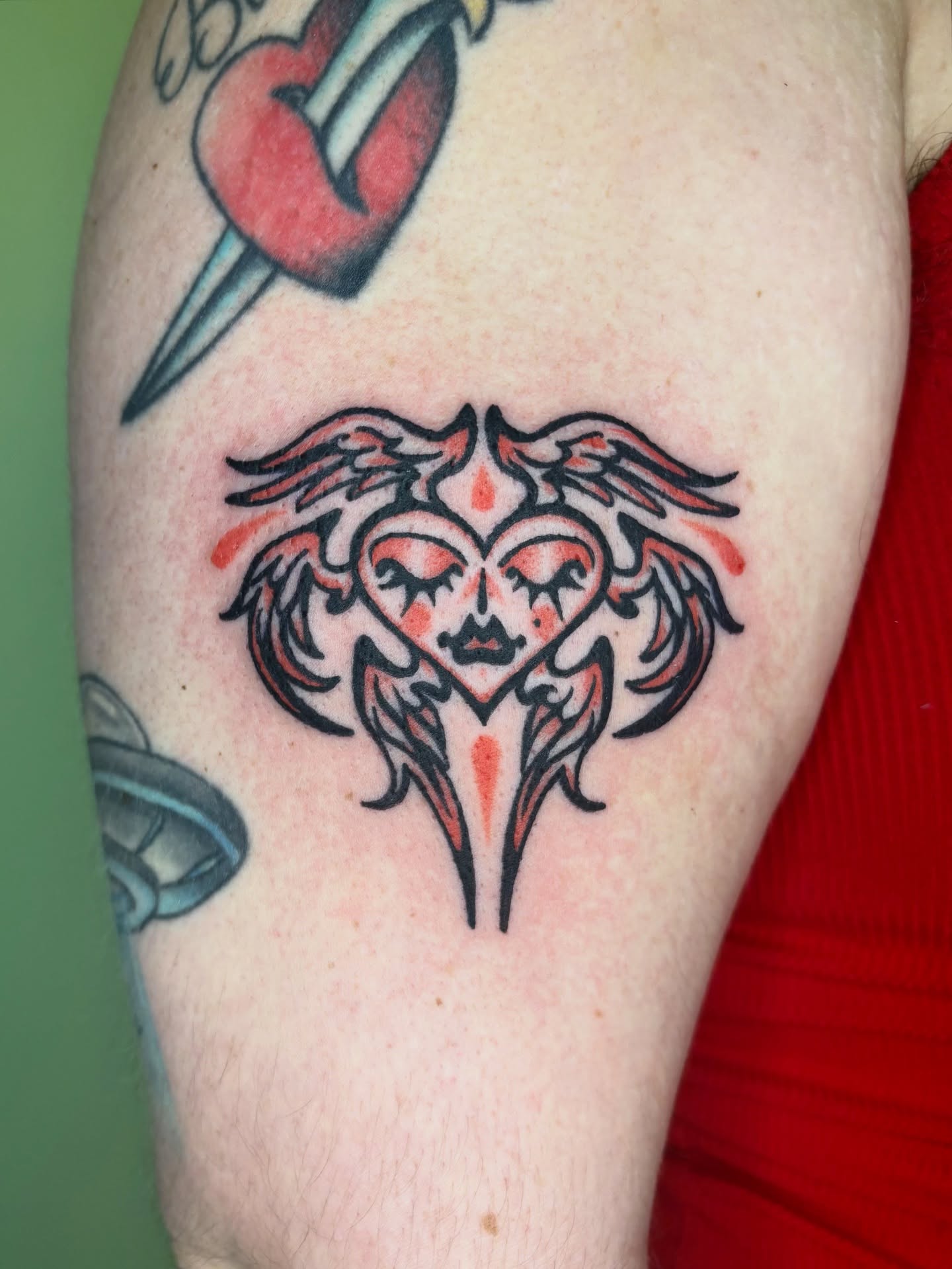 Heart with wings neo-traditional tattoo on the forearm by Grae