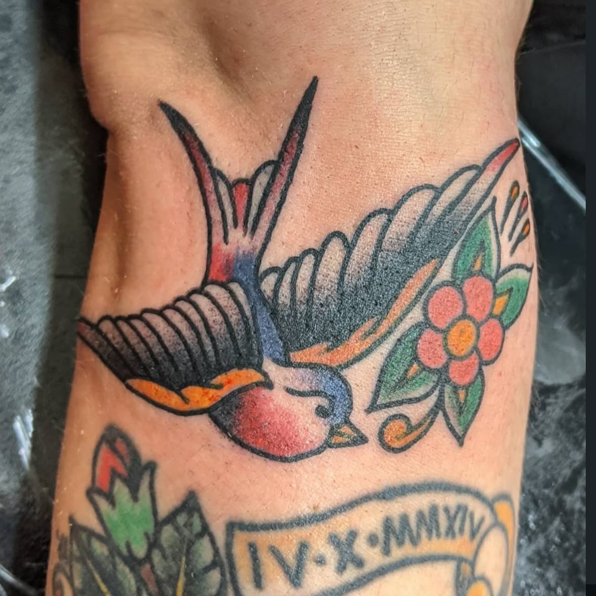 Swallow and flower American traditional tattoo on the ribs by Columbus tattoo artist