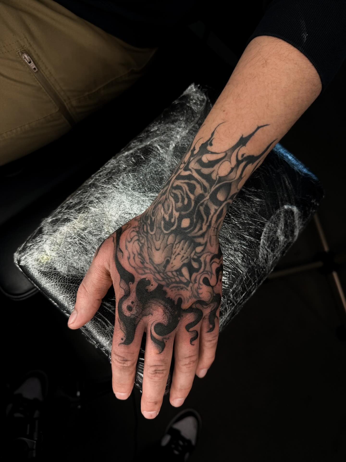 Floral design black and grey tattoo on the hand by Susie Maj