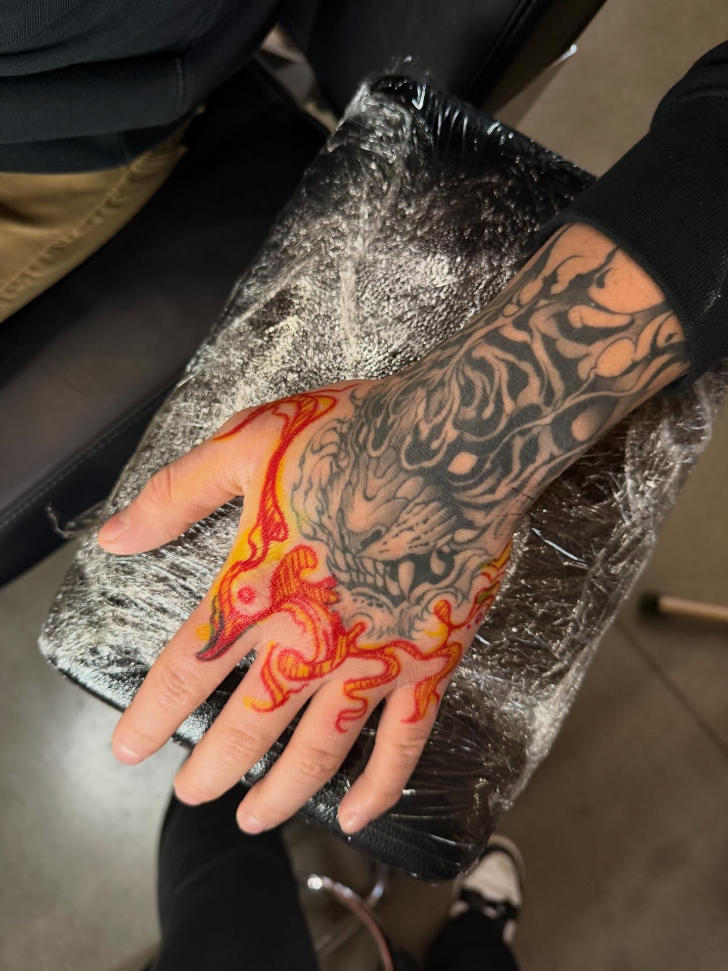 Flame neo-traditional tattoo on the hand by Susie Maj