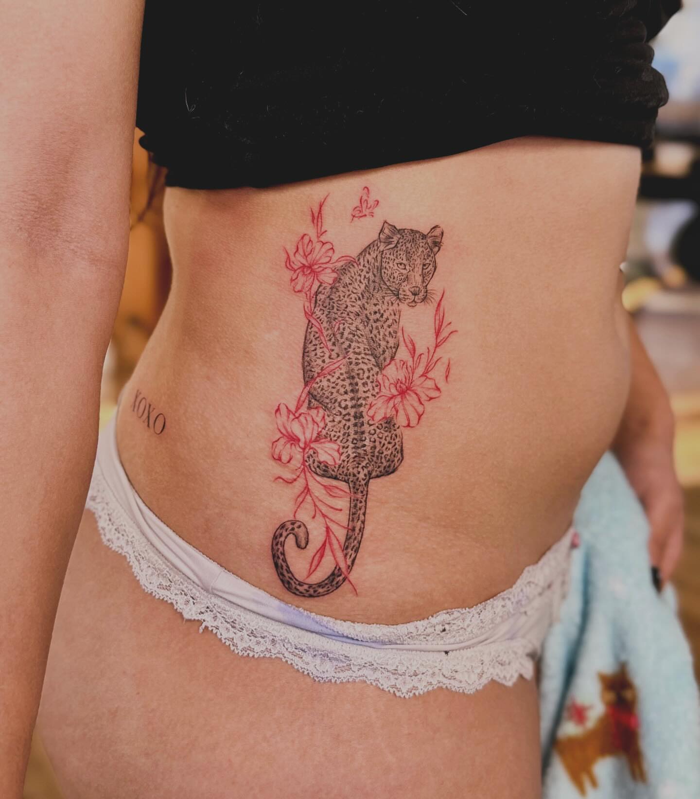 Leopard and flowers realism tattoo on the torso by Ethan