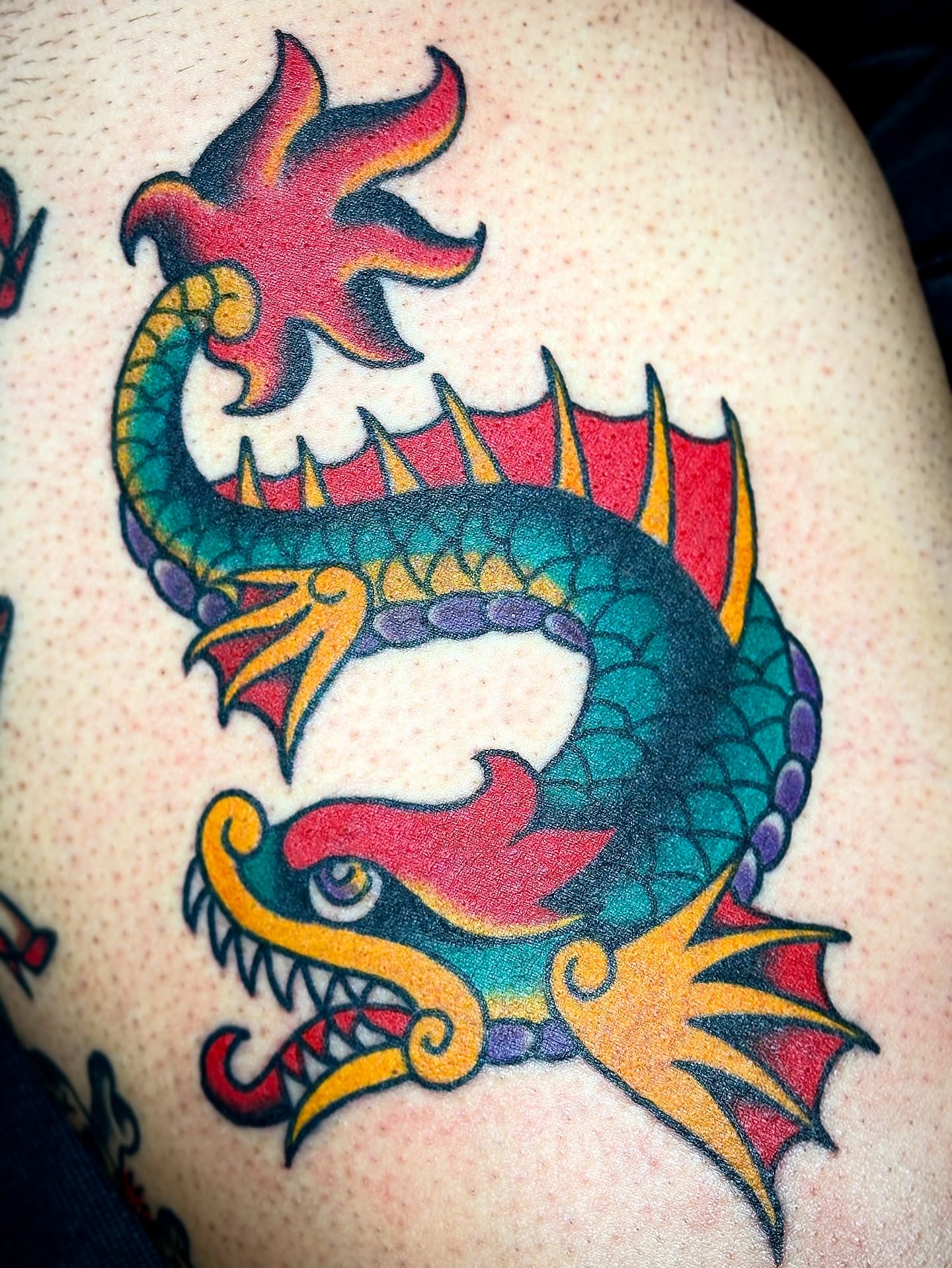 Dragon American traditional tattoo on the thigh by Carlos Gonzalez Tattoo, Dallas, Texas