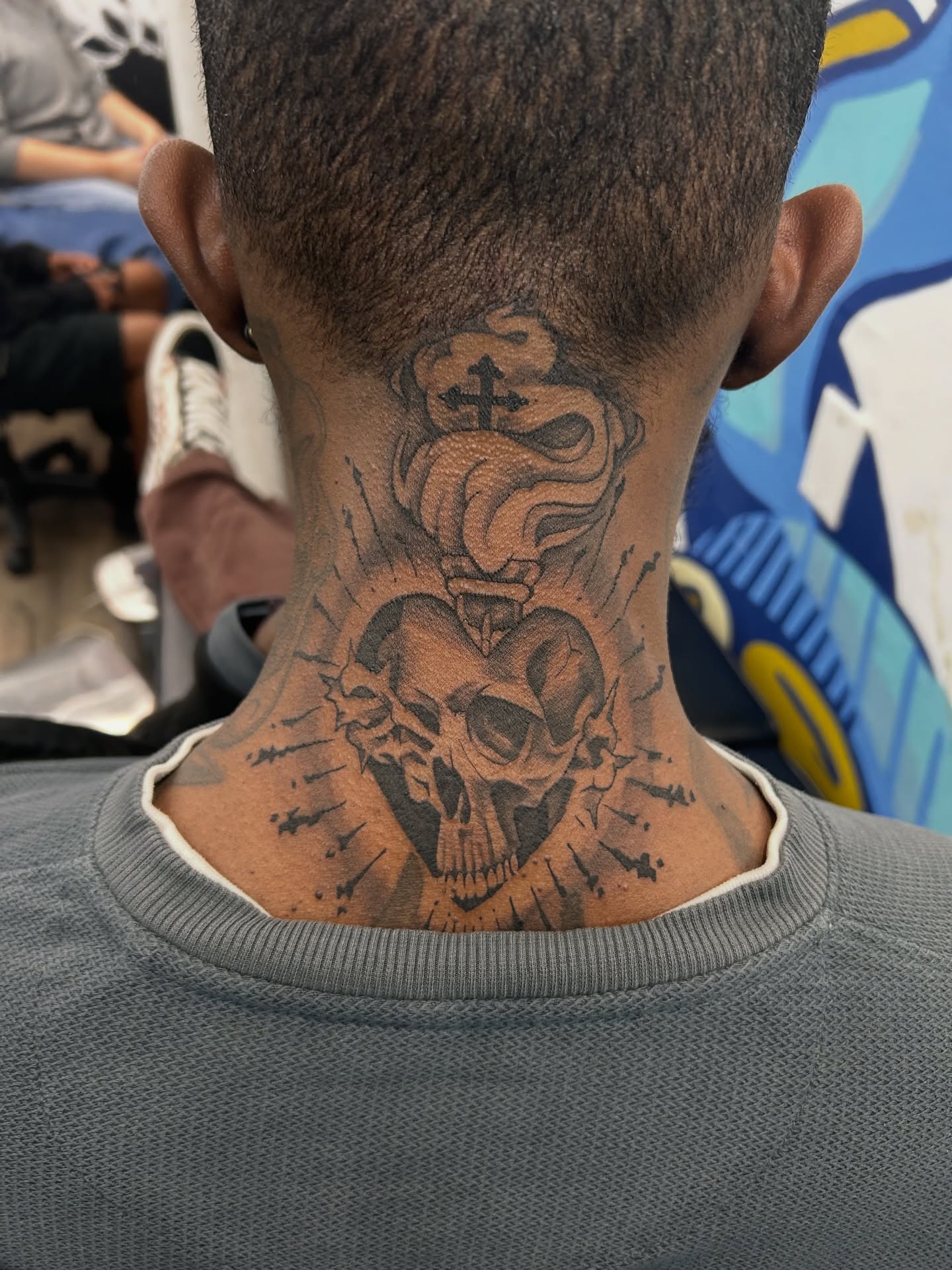 Skull and cross black and grey tattoo on the neck by Nigel🪓UNO