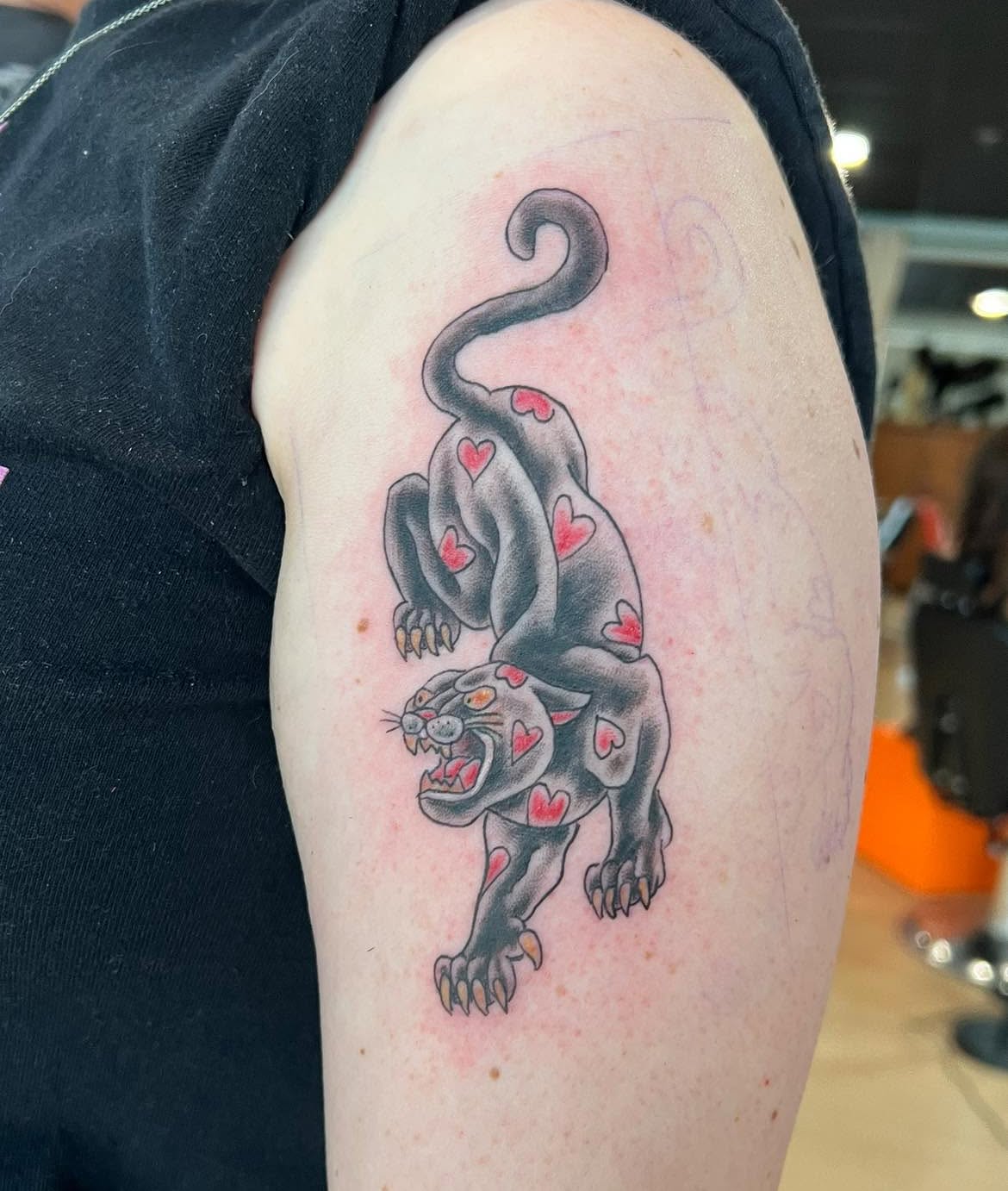 Panther with hearts American traditional tattoo on the shoulder by Jessica Kloos