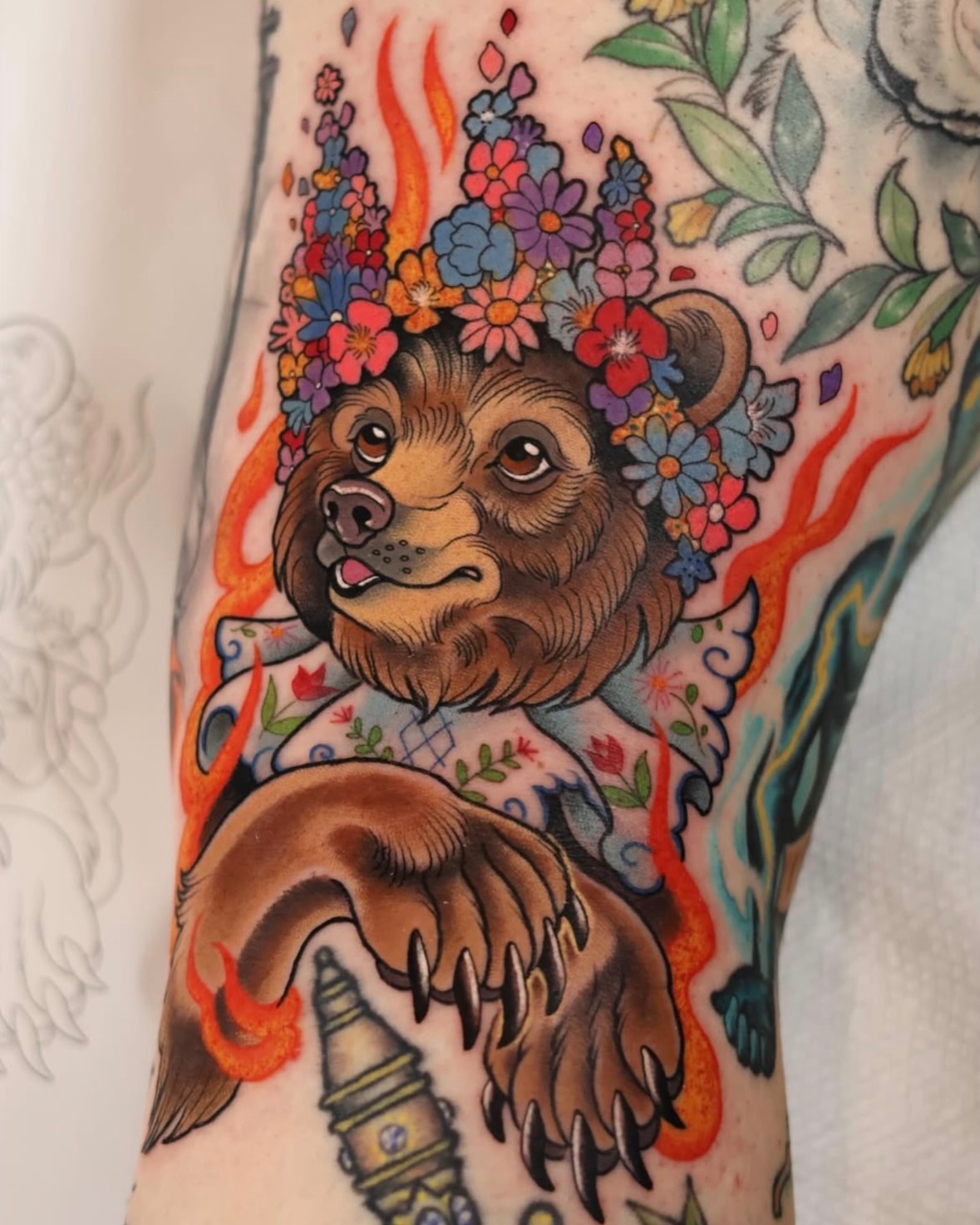 Bear with floral crown American traditional tattoo on the forearm by Sarah Baldwin