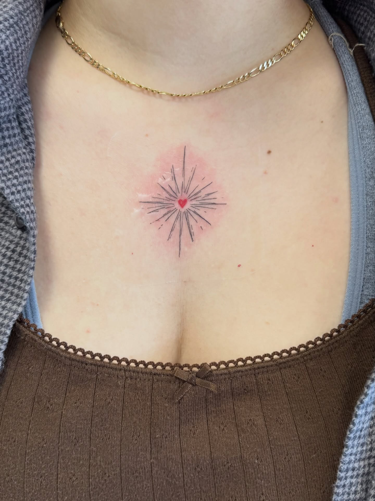 Heart with radiating lines geometric tattoo on the chest by Daniel Montoya, Charlotte, North Carolina