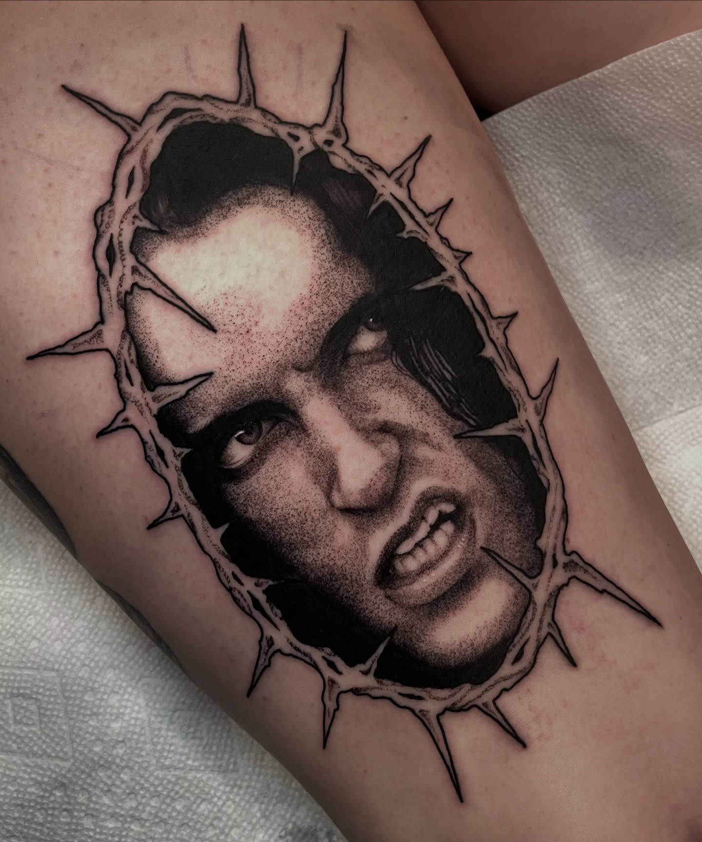 Crown of thorns dotwork tattoo on the thigh by Ian Spong