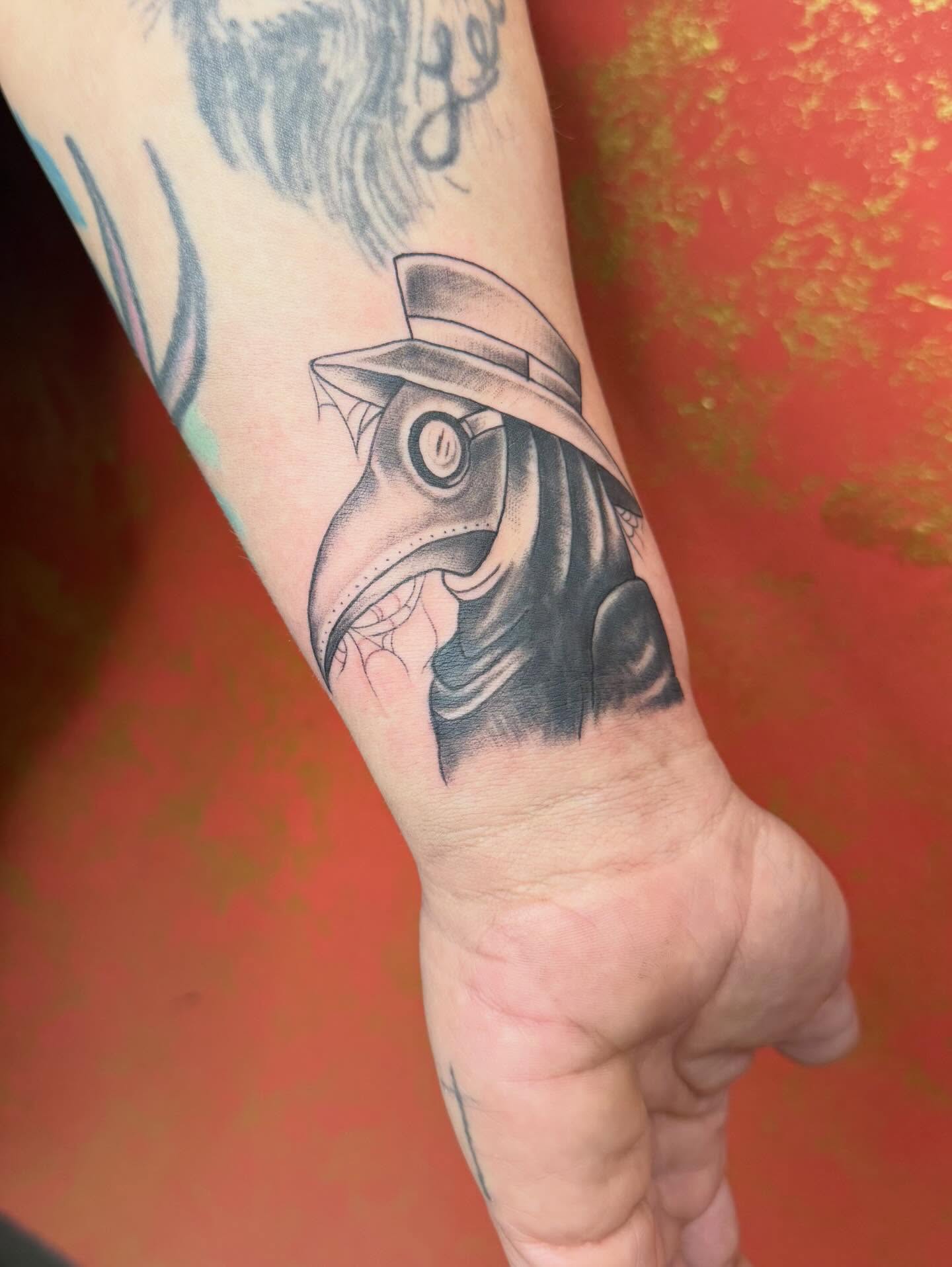 Plague doctor mask black and grey tattoo on the forearm by Imani