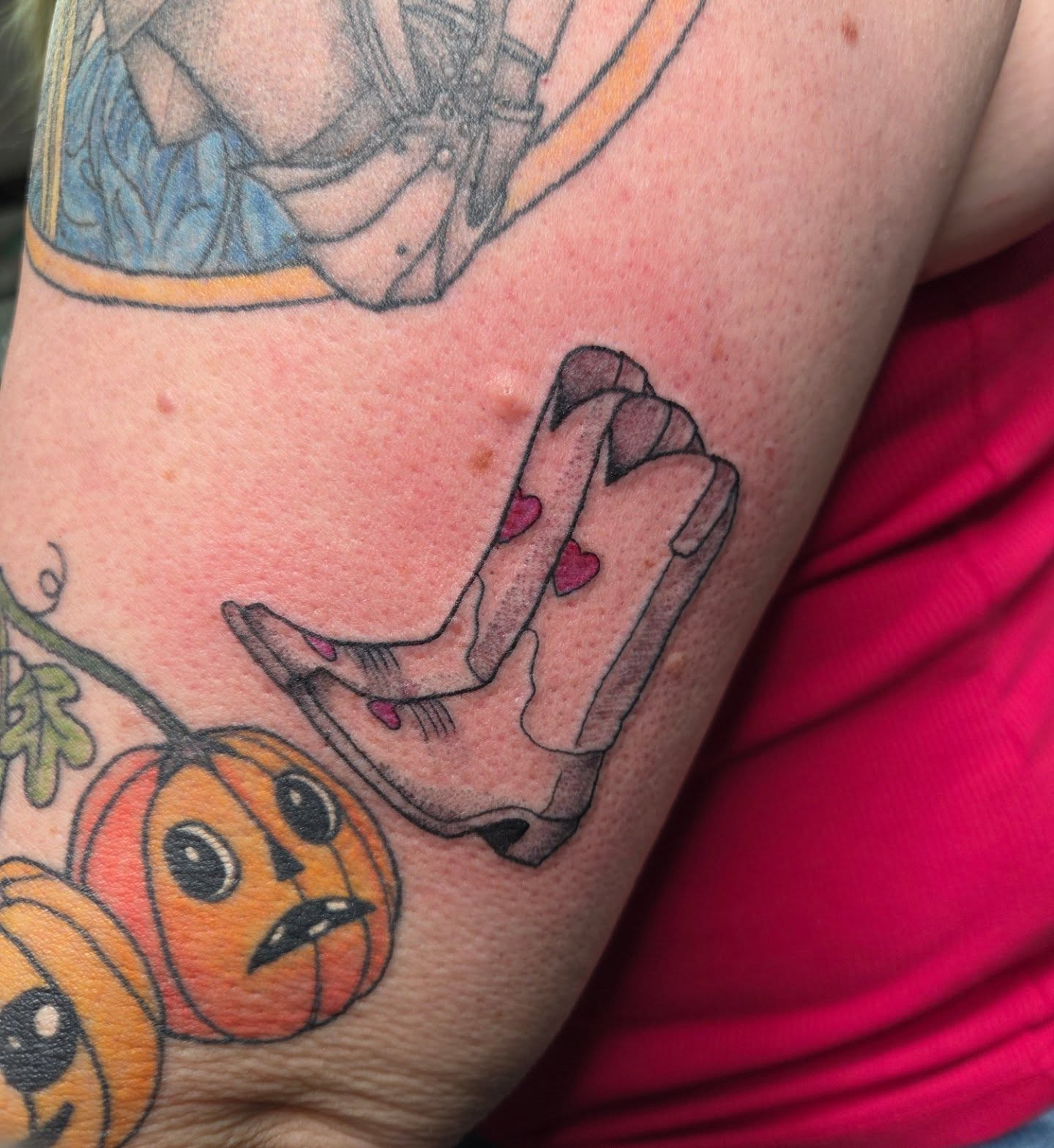 Hand with hearts American traditional tattoo on the forearm by Trinity Renee