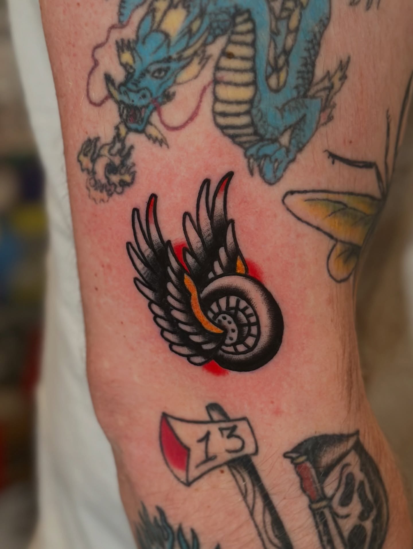 Winged tire American traditional tattoo on the forearm by Michael Williams