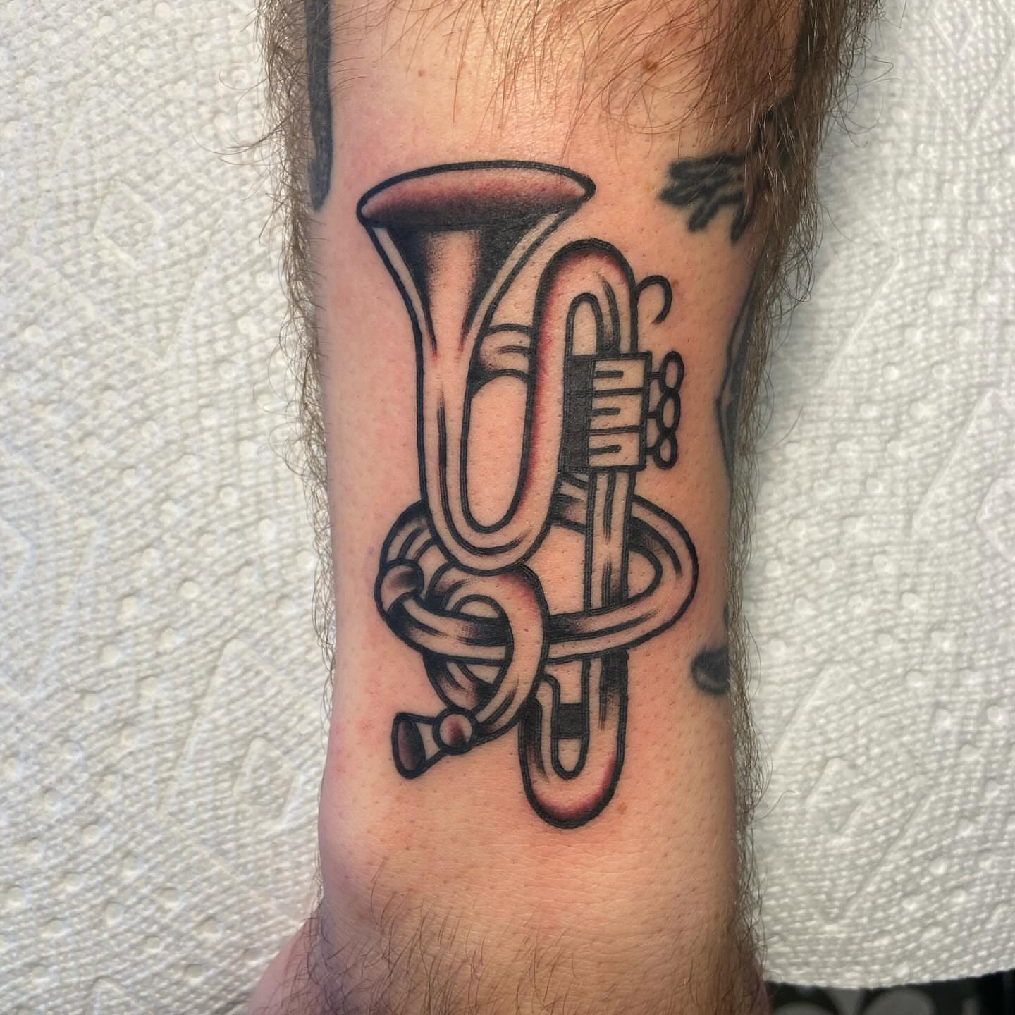 Trumpet black and grey tattoo on the forearm by Anthony Jaeger, Seattle, Washington