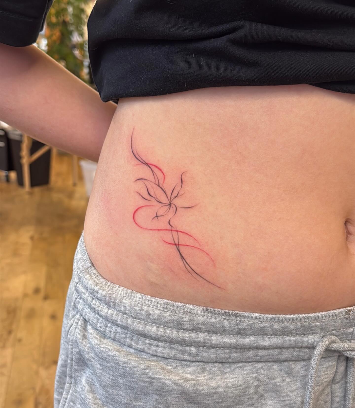 Abstract floral design fine line tattoo by Ethan