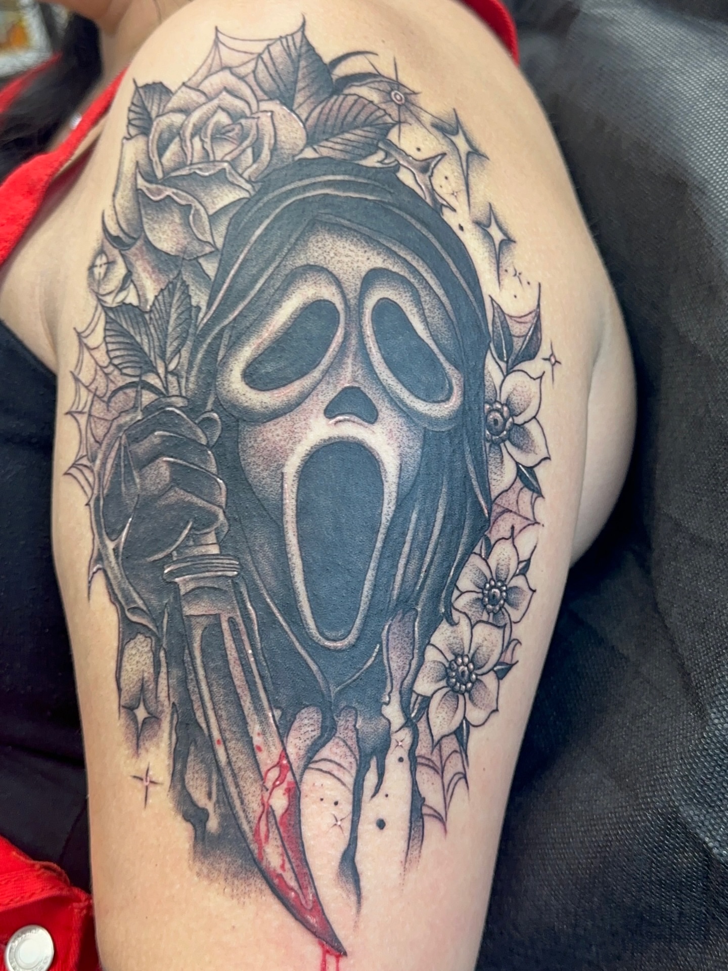 Scream mask black and grey tattoo on the thigh by Stevie O'Dell