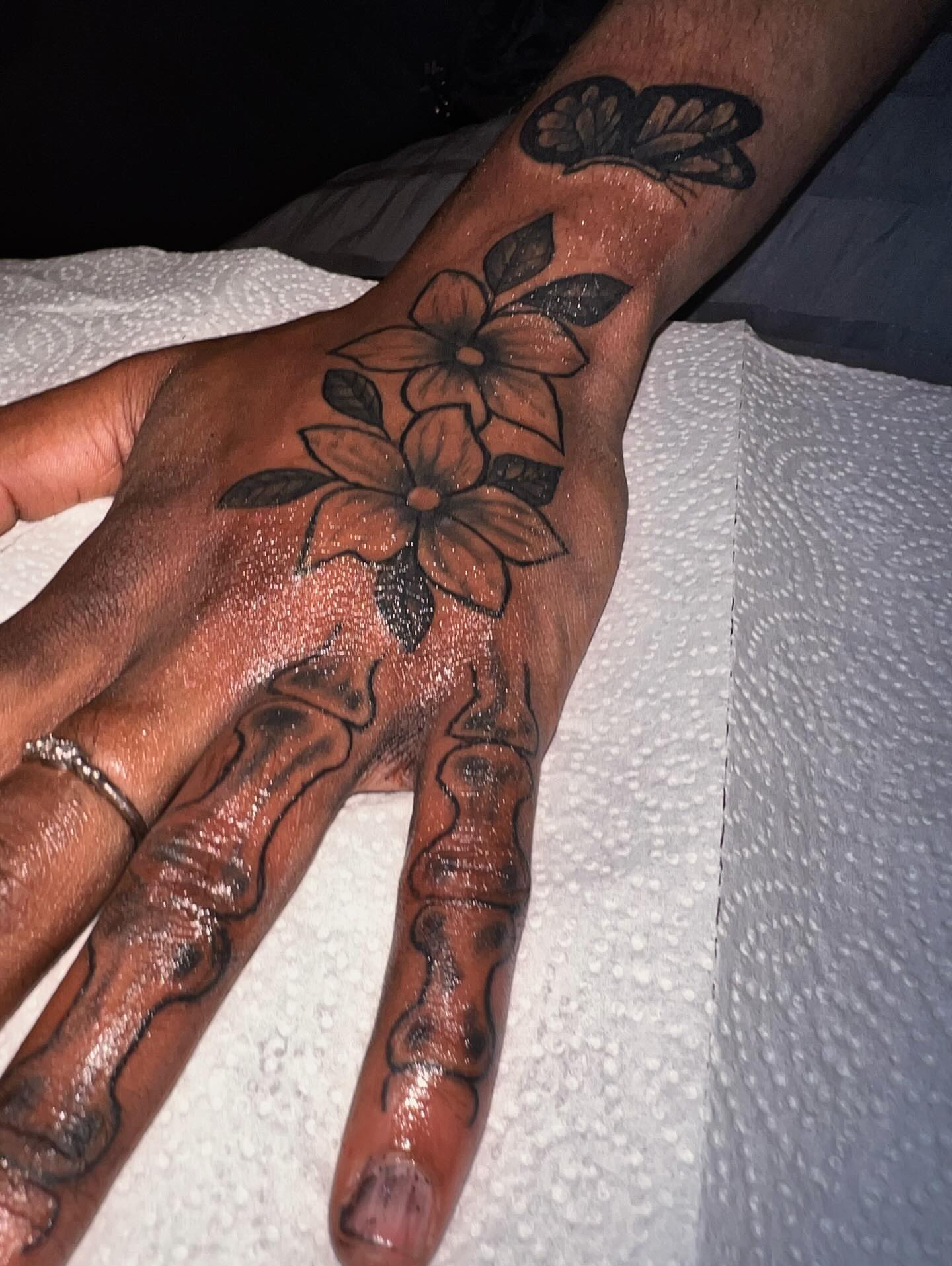 Flowers black and grey tattoo on the hand by Sonya son tattoos and piercings