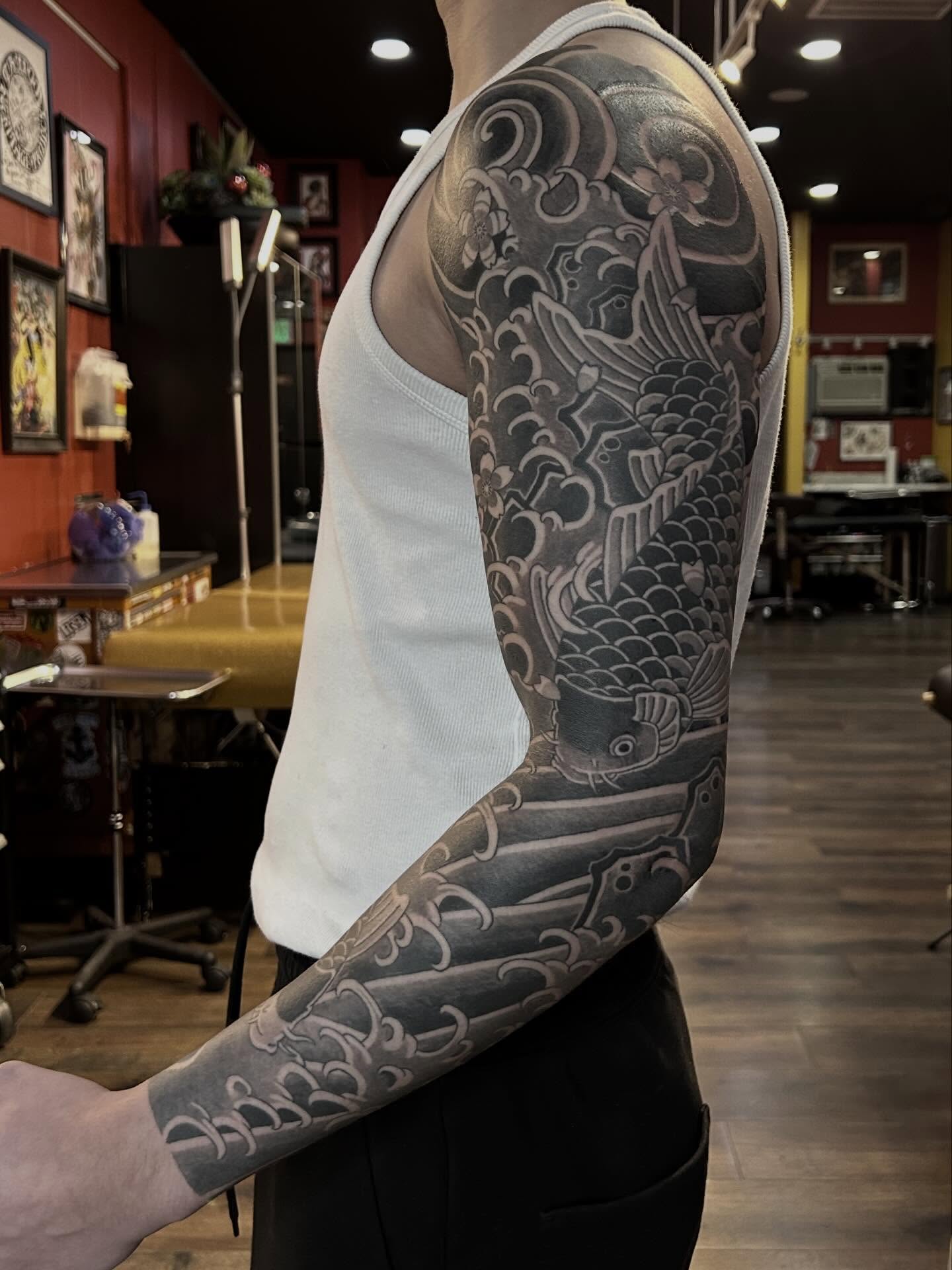 Koi fish japanese irezumi tattoo on the upper arm by Tako, Seattle, Washington