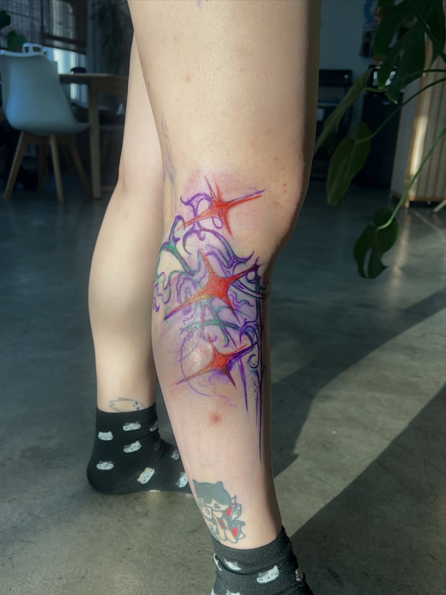 Abstract starburst watercolor tattoo on the calf by sebs phạm, Los Angeles, California
