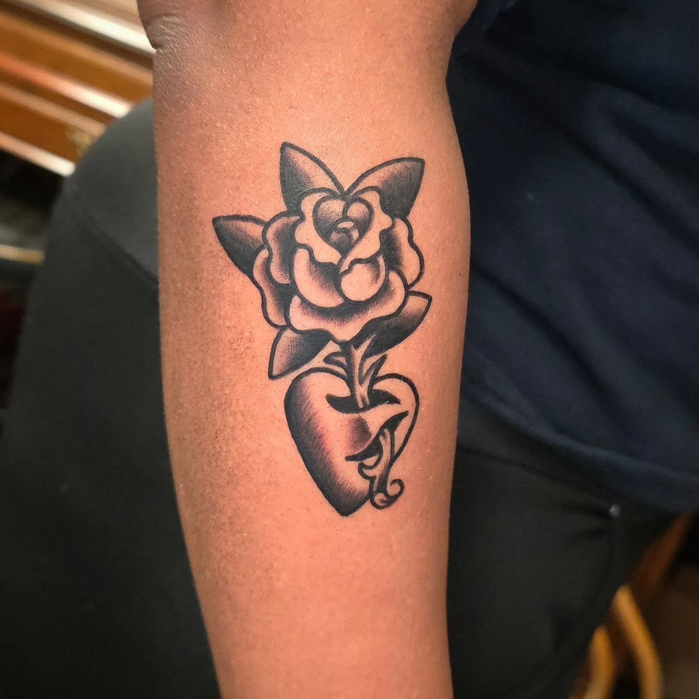 Rose and heart black and grey tattoo on the forearm by Joseph Jeffers