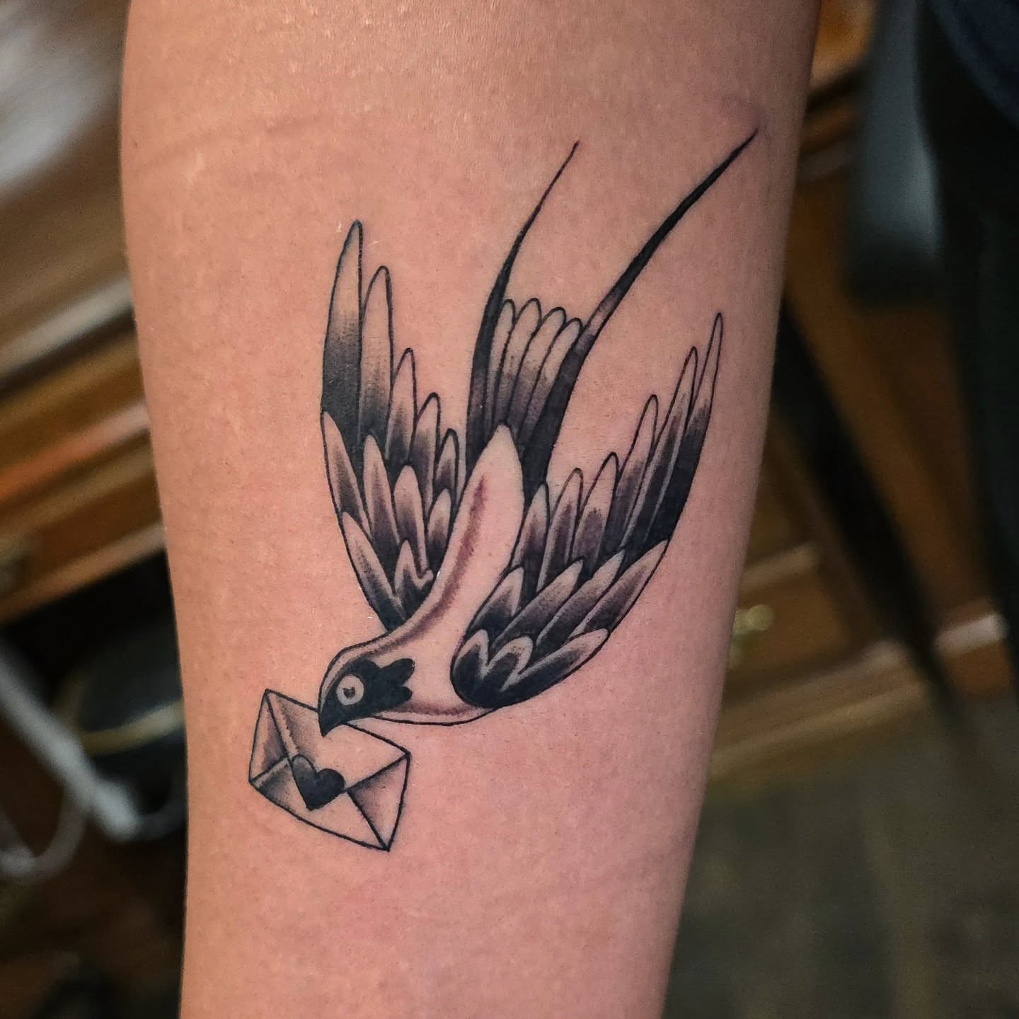 Swallow with envelope American traditional tattoo on the forearm by Joseph Jeffers