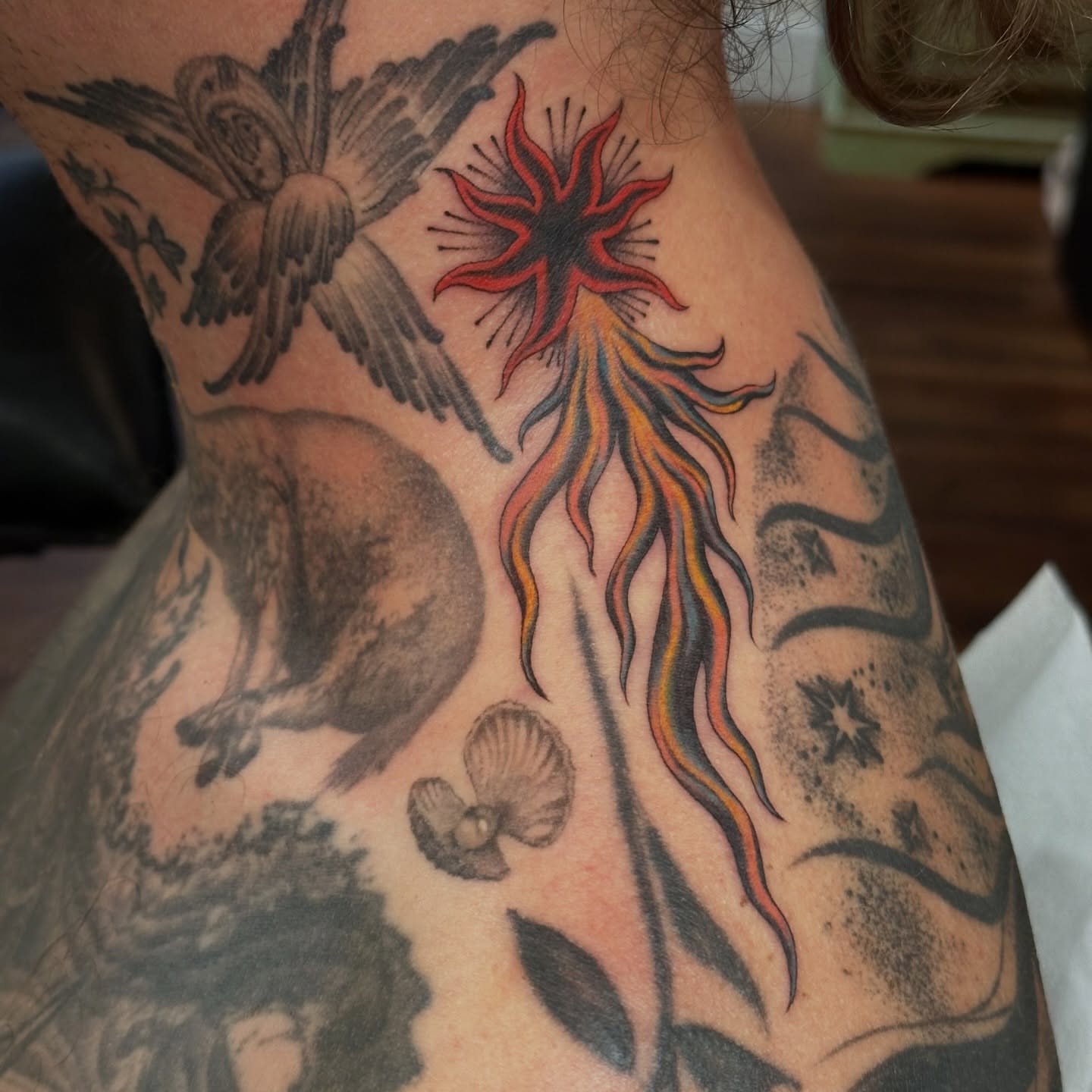 Sunburst and fox neo-traditional tattoo on the neck by Bree Lin
