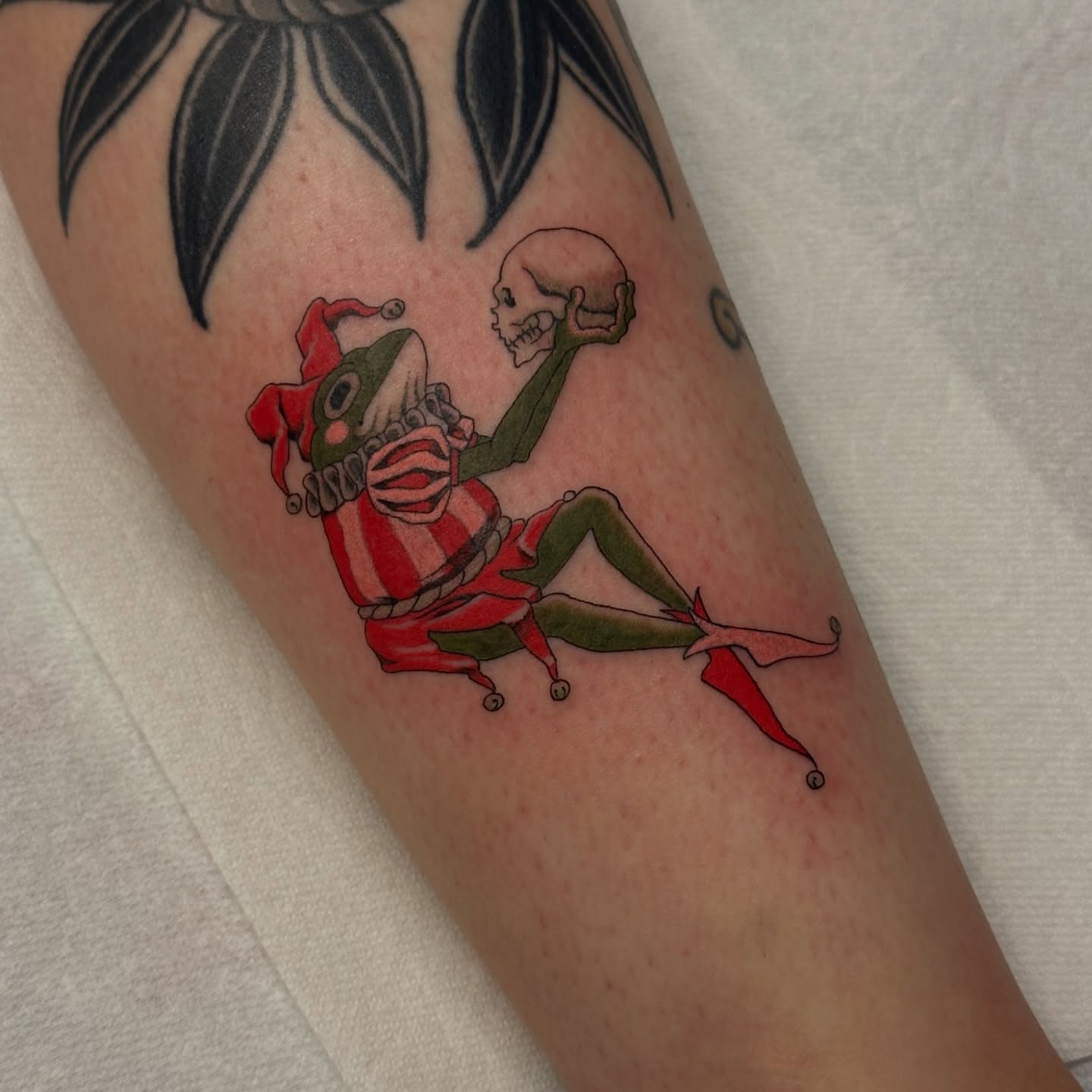 Clown and skull American traditional tattoo on the forearm by Bree Lin