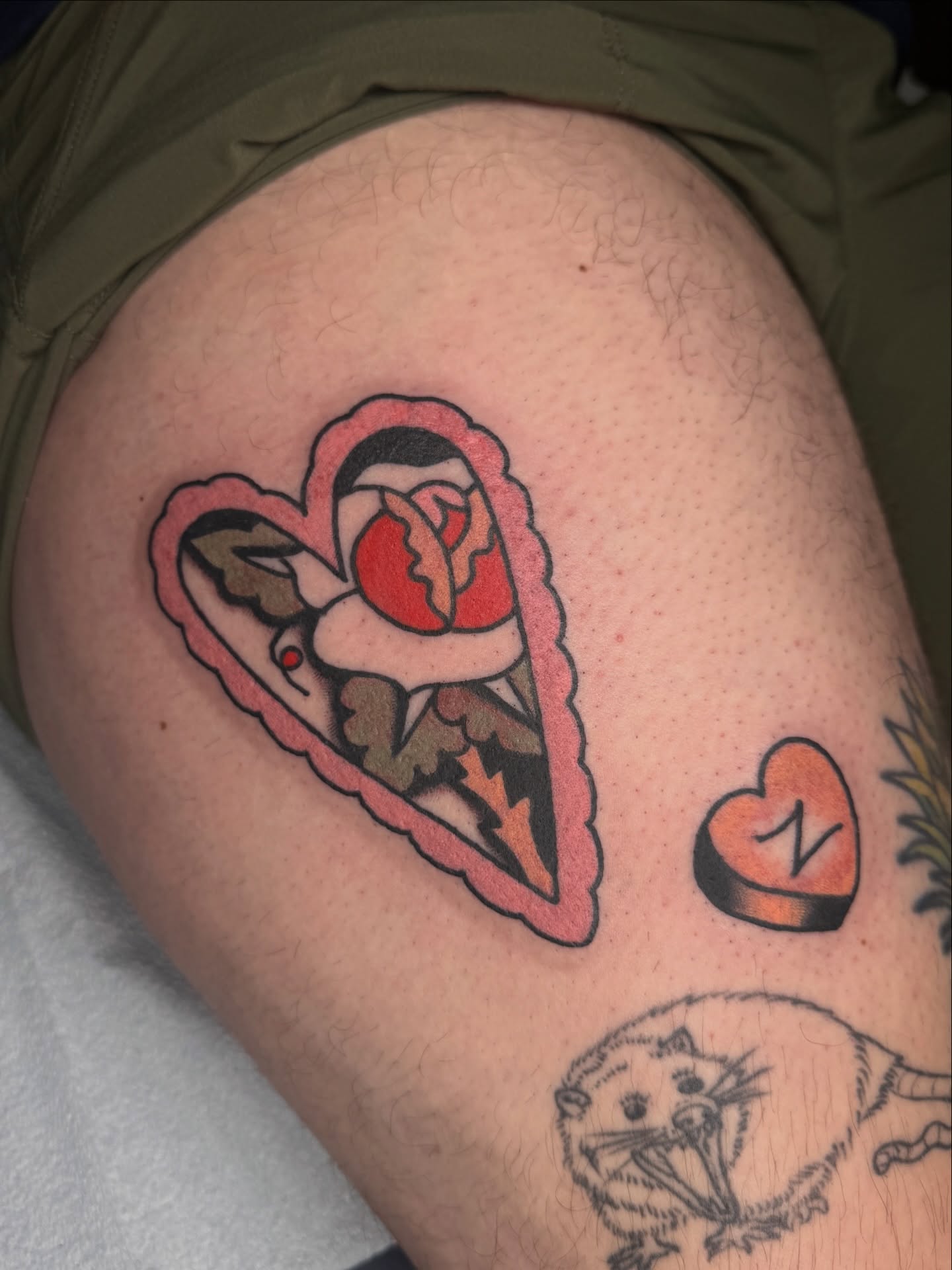 Heart with rose American traditional tattoo on the thigh by lily gustave i tattoo