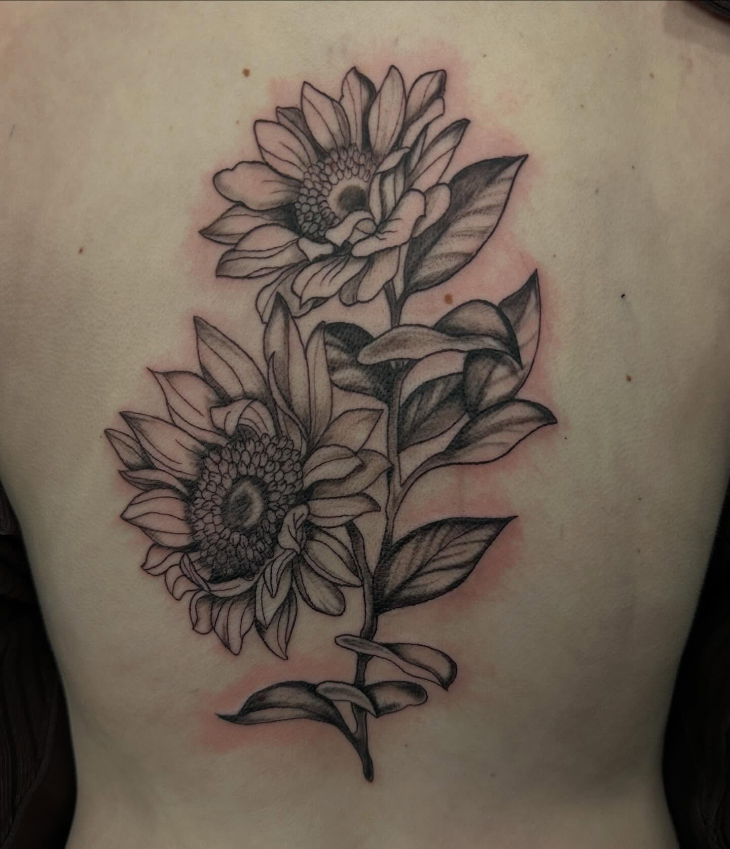 Sunflower realism tattoo on the back by Mika'la Berry