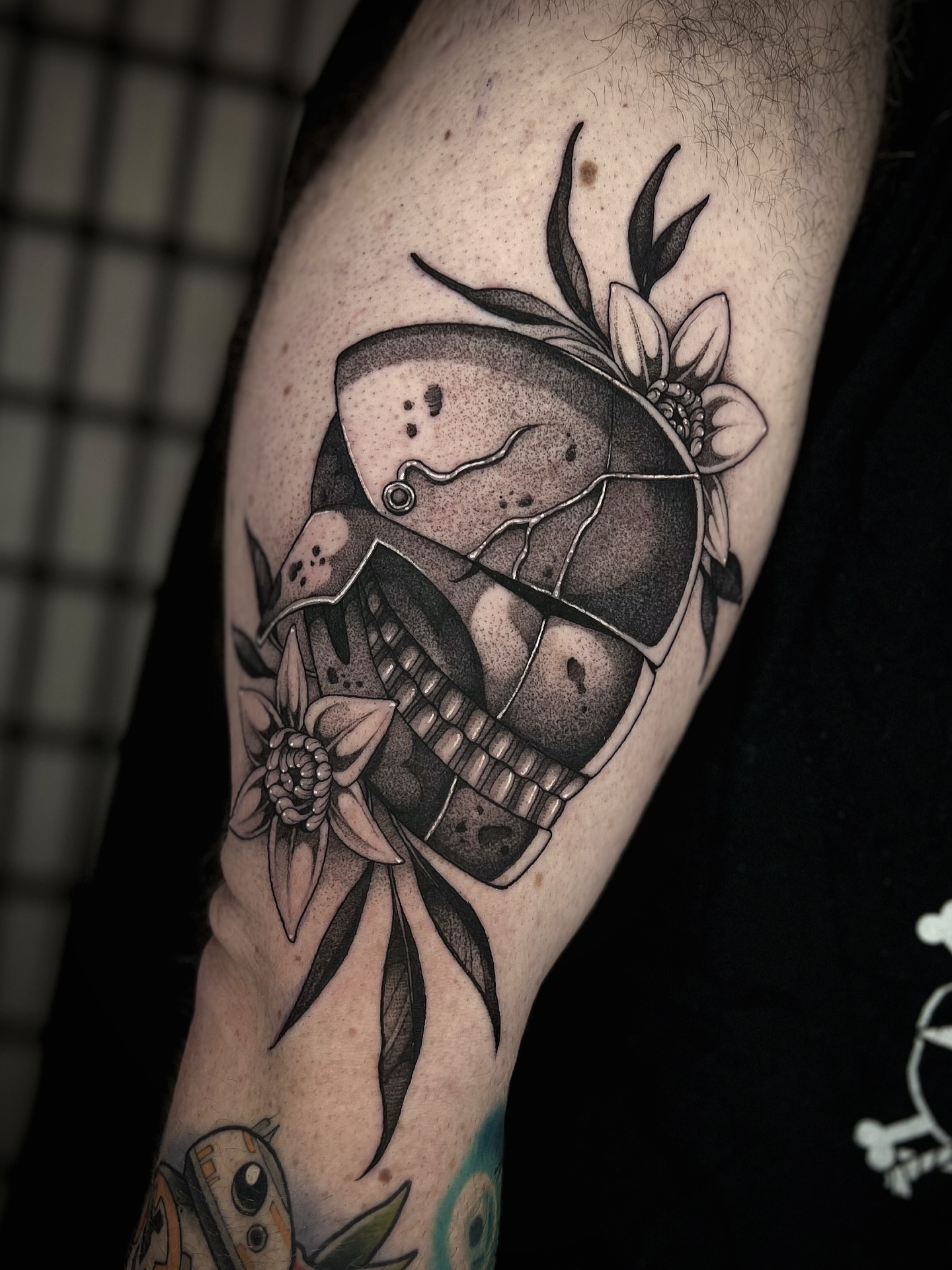 Skull with flowers dotwork tattoo on the forearm by Kaysee Shuster