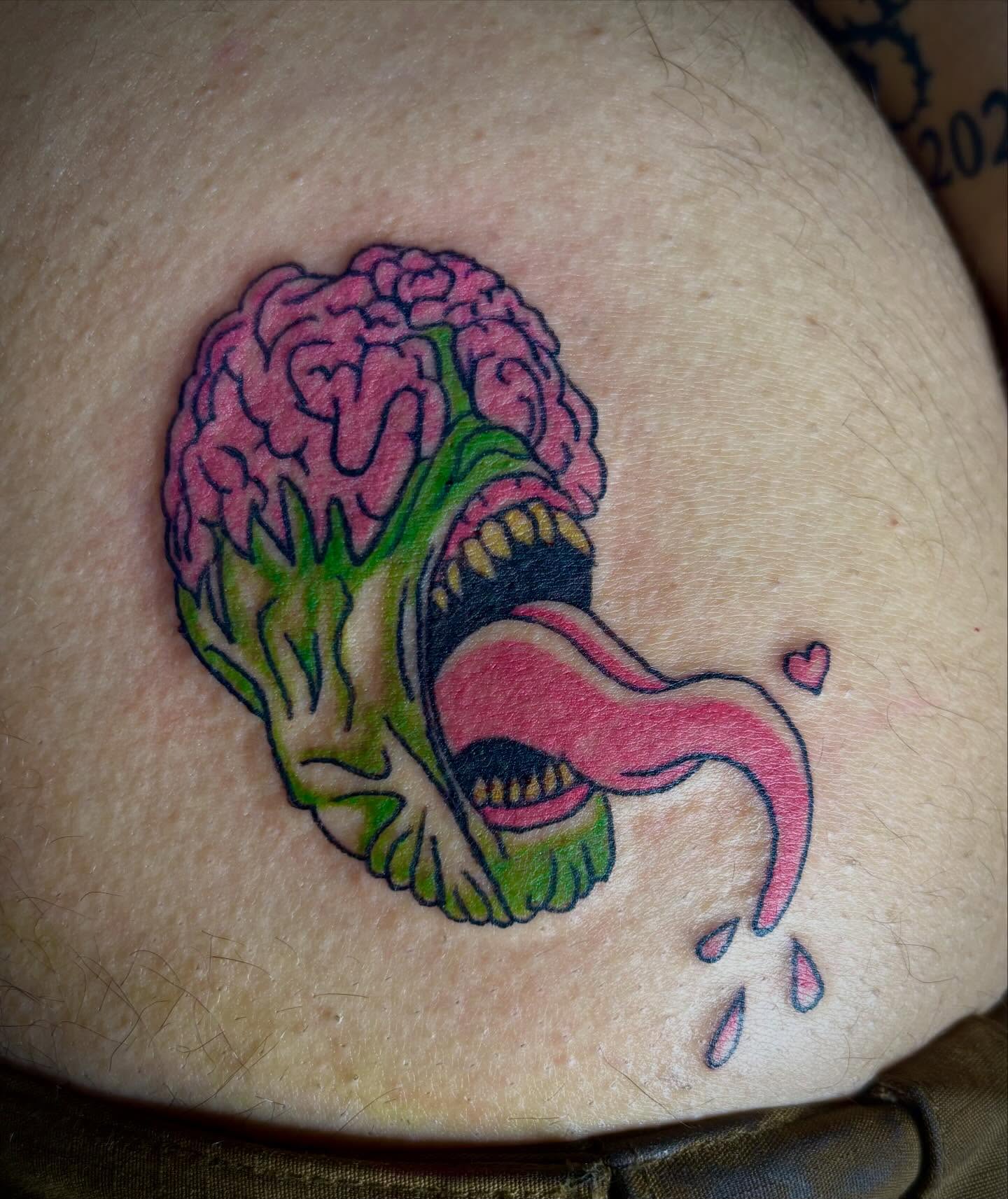 Broccoli with mouth new school tattoo on the thigh by Rayne