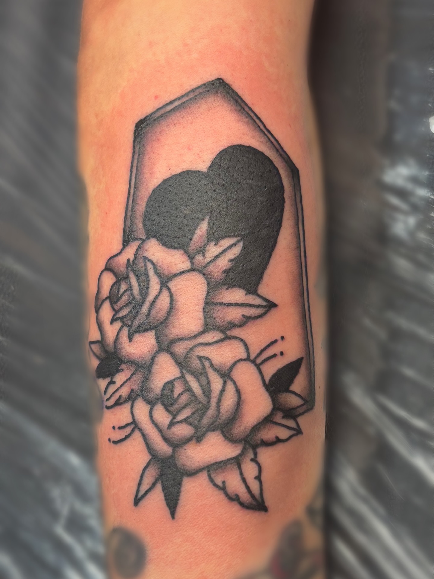 Roses and heart black and grey tattoo on the forearm by Bree Burgess