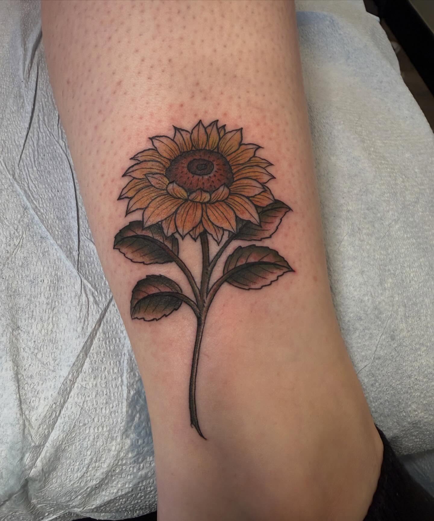 Sunflower realism tattoo on the forearm by Rebecca Basma Smith