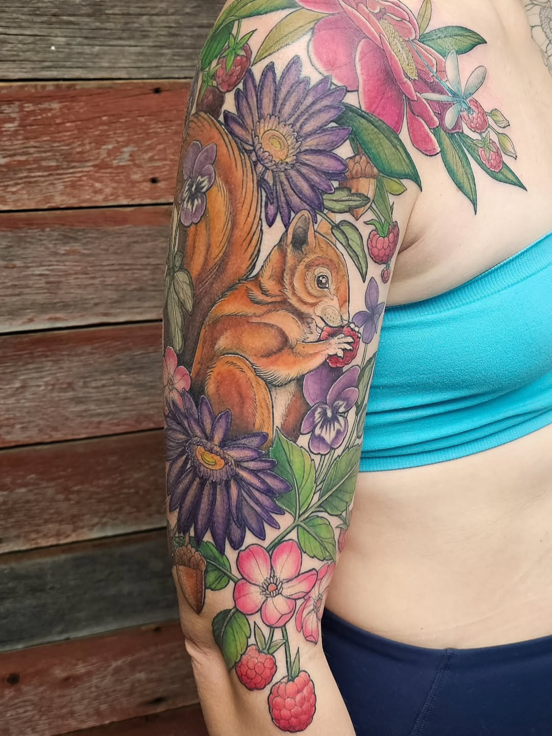 Squirrel and flowers realism tattoo on the forearm by Savannah