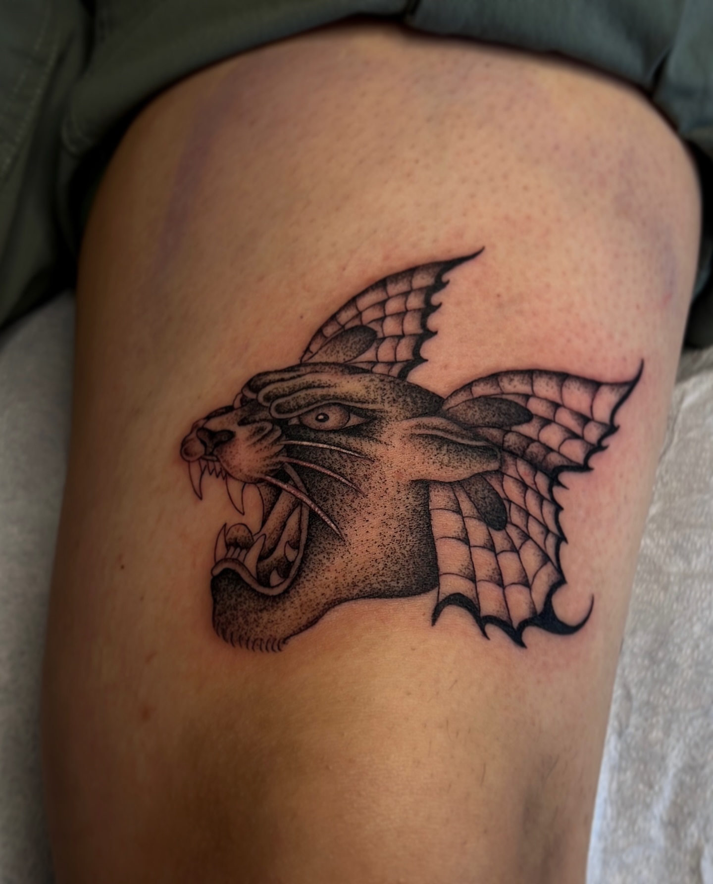 Panther dotwork tattoo on the thigh by David Delacruz