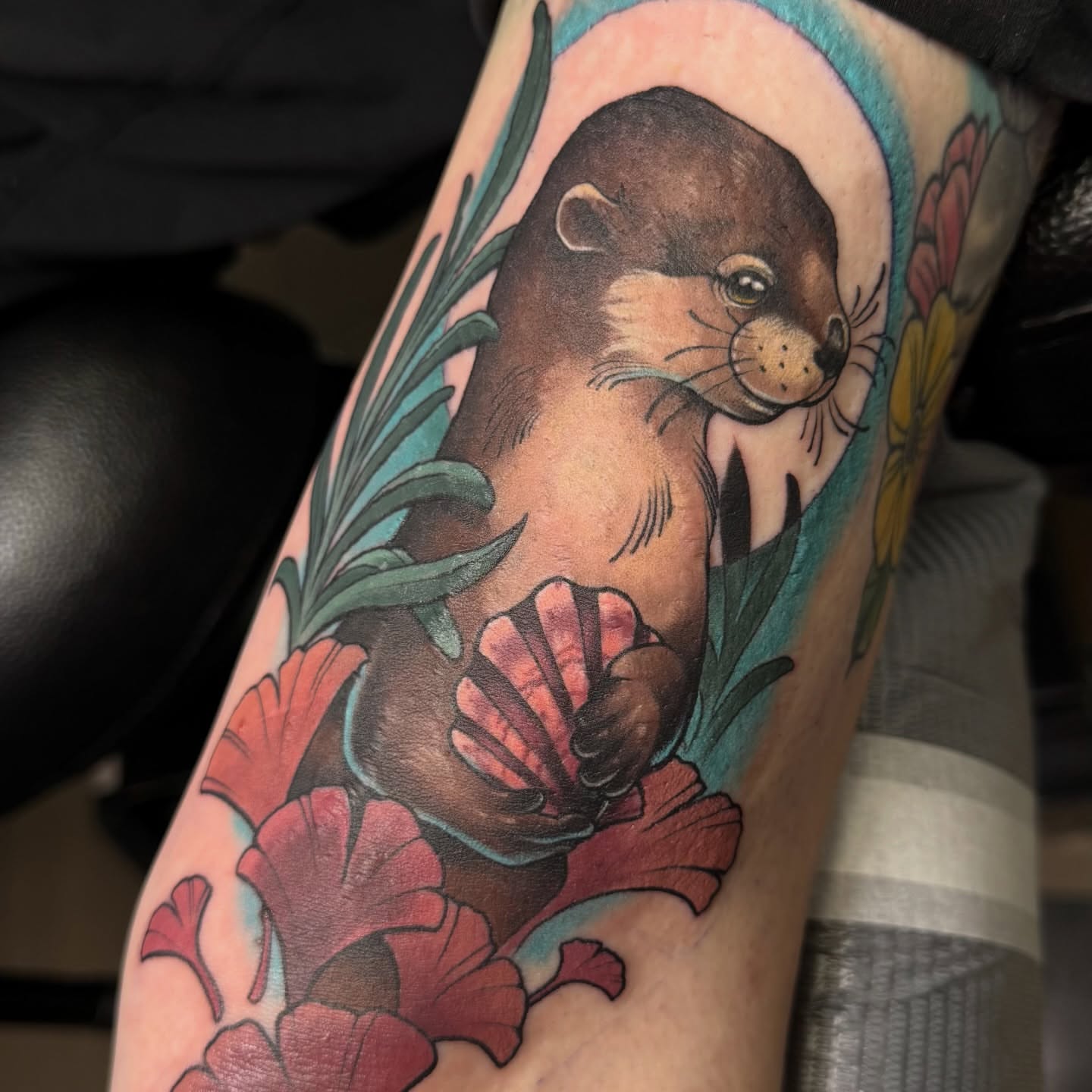 Otter and flowers American traditional tattoo on the forearm by Bri